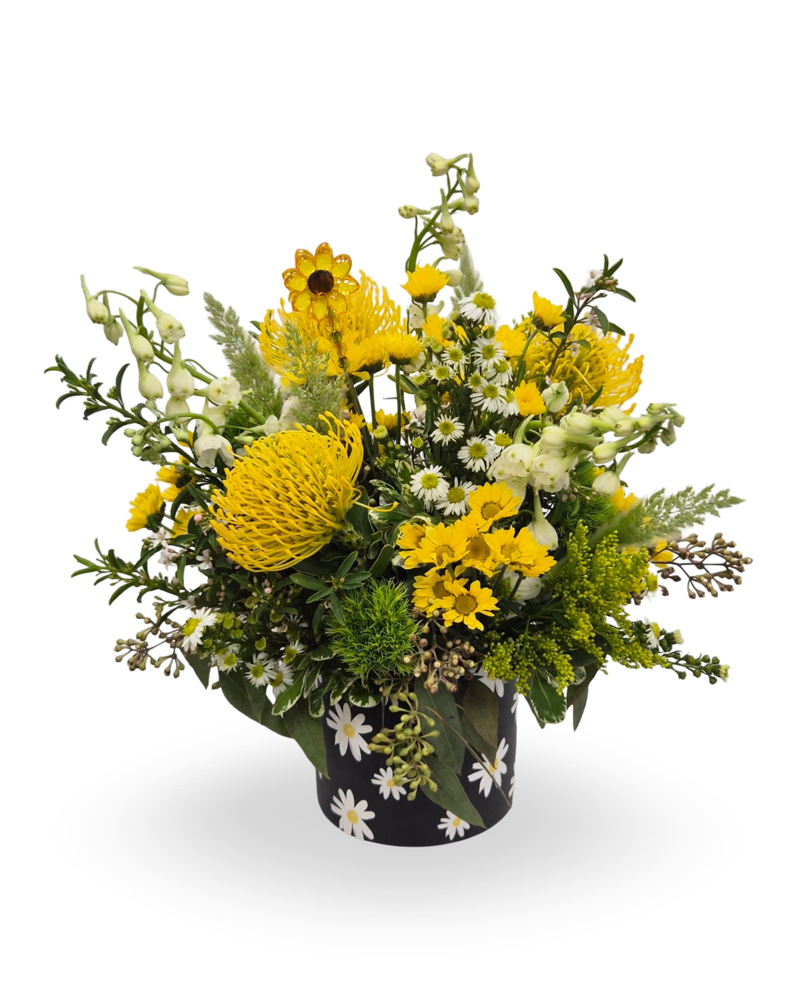 Sweet Daisy - Select this bright mix of yellow blooms such as chrysanthemum, pin cushion protea and white bells gonna, accented with greenery and a keepsake flower stake. Approximately 17” x 15” x 14”