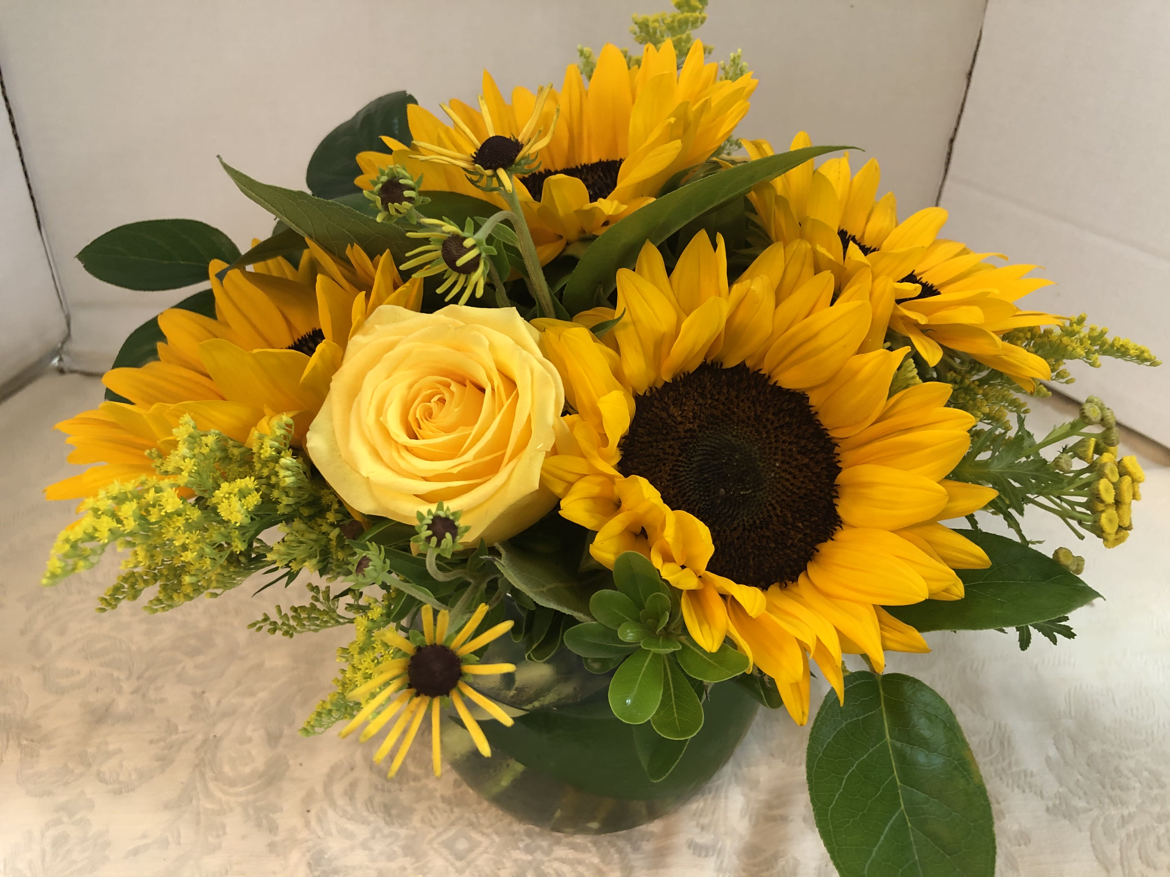 Sunshine Morn  Summer Arrangement - Sunflowers, Roses, Touch of Summer, Solidago, Fancy Greens.  Note:   There are a variety of Sunflowers.  We cannot guarantee  which variety will be available.