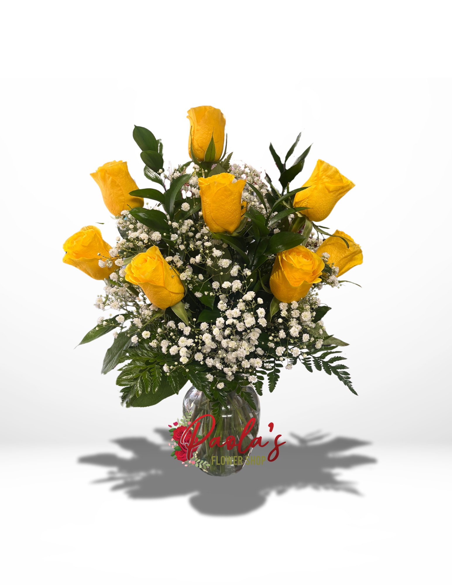 Yellow roses in a clear glass vase with white baby's breath