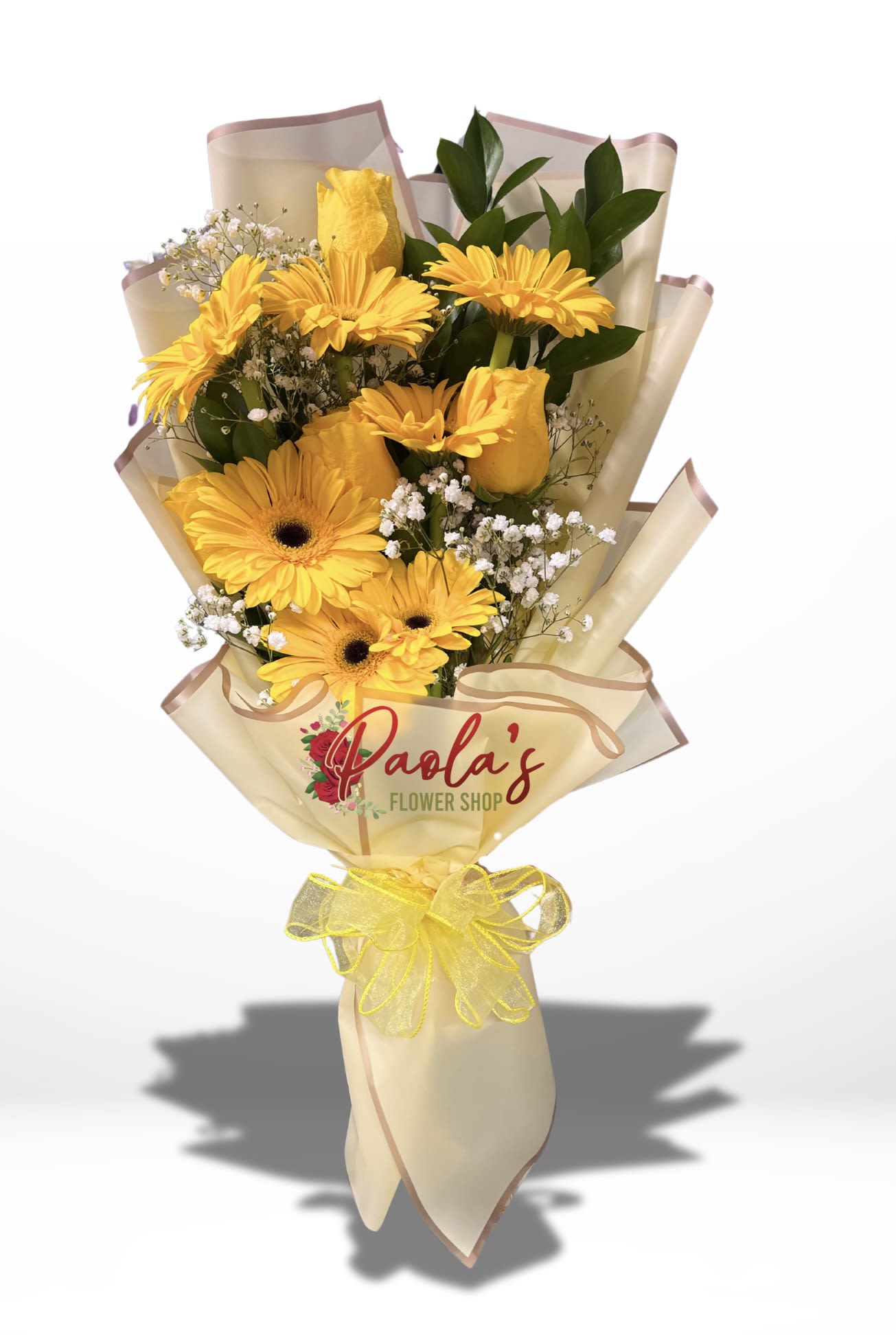 Yellow gerbera bouquet wrapped in cream paper with a yellow ribbon