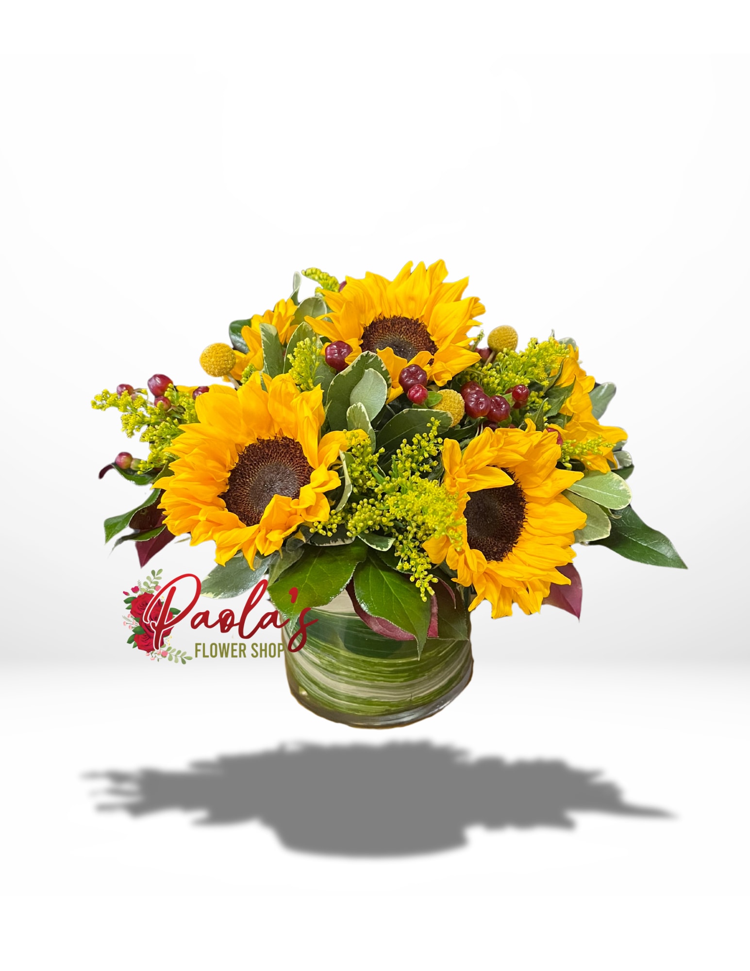 Sunny Sunflower Galore - This beautiful bouquet showcases bright sunflowers paired with fresh green fillers and vibrant red berries.  Ideal for infusing your space with a bit of nature, each sunflower radiates warmth and joy in any setting. The lush green fillers create a natural foundation, while the cheerful red berries introduce a fun element.