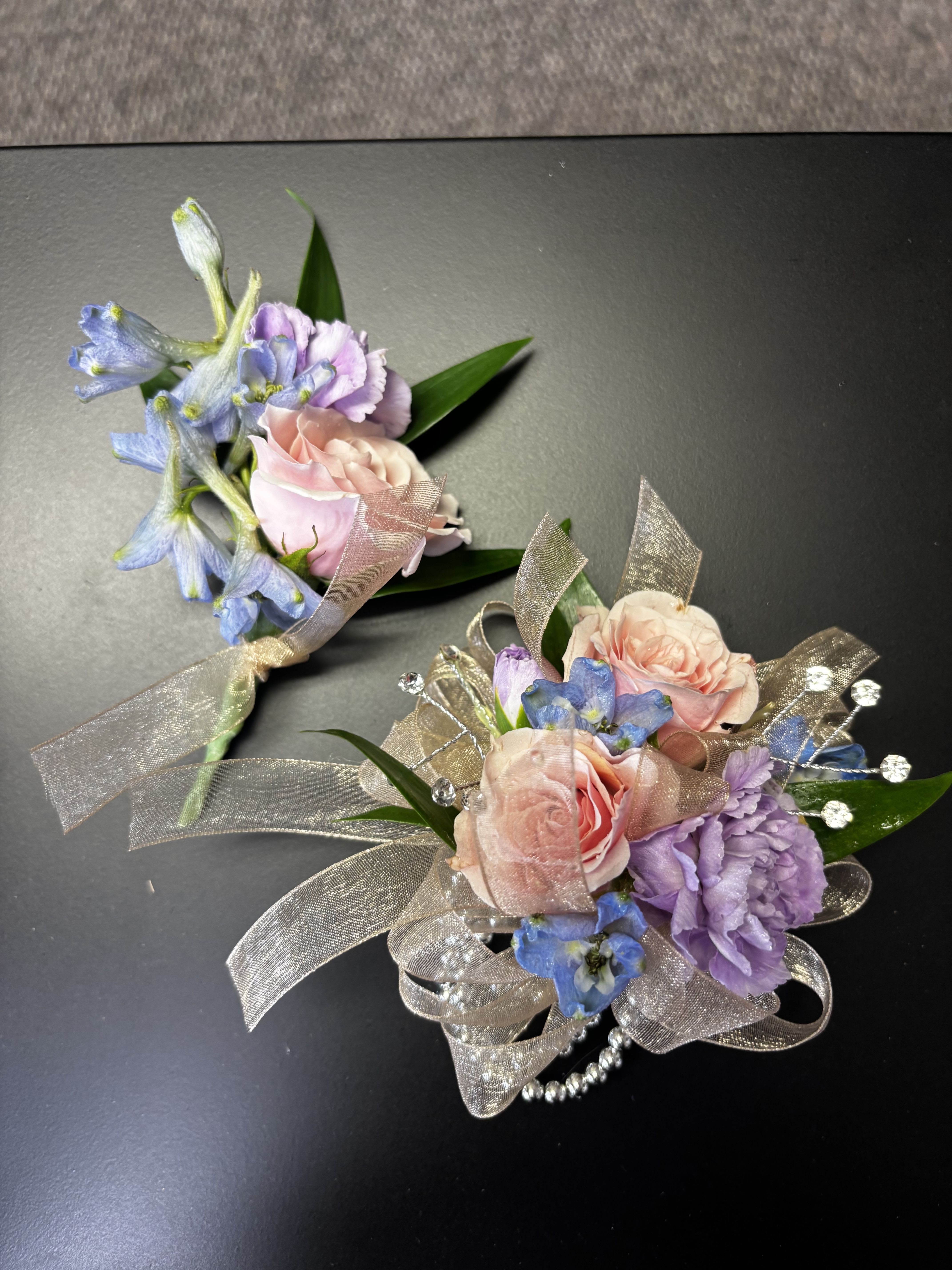 Daddy’s Little Sweetheart Set - A beautiful floral pair featuring pink spray roses, lavender mini carnations , blue delphinium, and sparkling details for a night to remember.