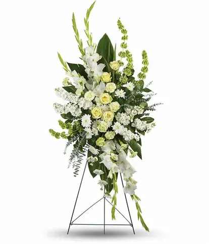 Soft Spring Meadow (Easel Stand) - Our White &amp; Green Seasonal Sympathy Arrangements are thoughtfully designed using the freshest seasonal blooms in soft whites and natural greenery. Each piece symbolizes peace, purity, and remembrance, offering comfort and elegance during times of loss. Handcrafted with care, these arrangements provide a timeless tribute to honor and celebrate a loved one’s life.