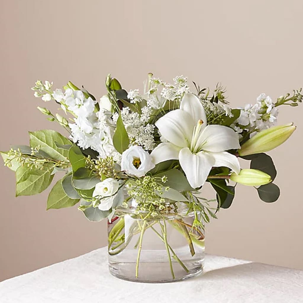 Alluring Elegance Bouquet - A stunning arrangement of fresh Asiatic lilies, white Veronica, white stock, Queen Anne's lace, silver dollar eucalyptus, and seeded eucalyptus.   Designed for elegance, this handcrafted bouquet is perfect for weddings, anniversaries, sympathy flowers, or upscale home decor.  Approximately 18" H x 15" W. Order now for fresh flower delivery! 