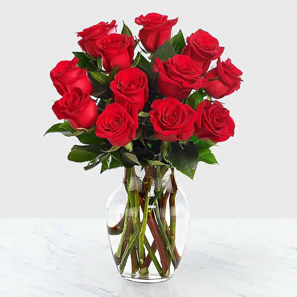 Classic Red Roses Bouquet - Classic Red Roses Bouquet with a simple glass vase creating a timeless expression. Delivered in a clear glass vase.  Perfect for anniversaries, declarations of love, or simply to say "I care," this arrangement is the very symbol of the heart's deepest sentiments.  Approximately 16" H x 14" W.  Standard 12 stems.  Deluxe 18 stems.  Premium 24 stems. 