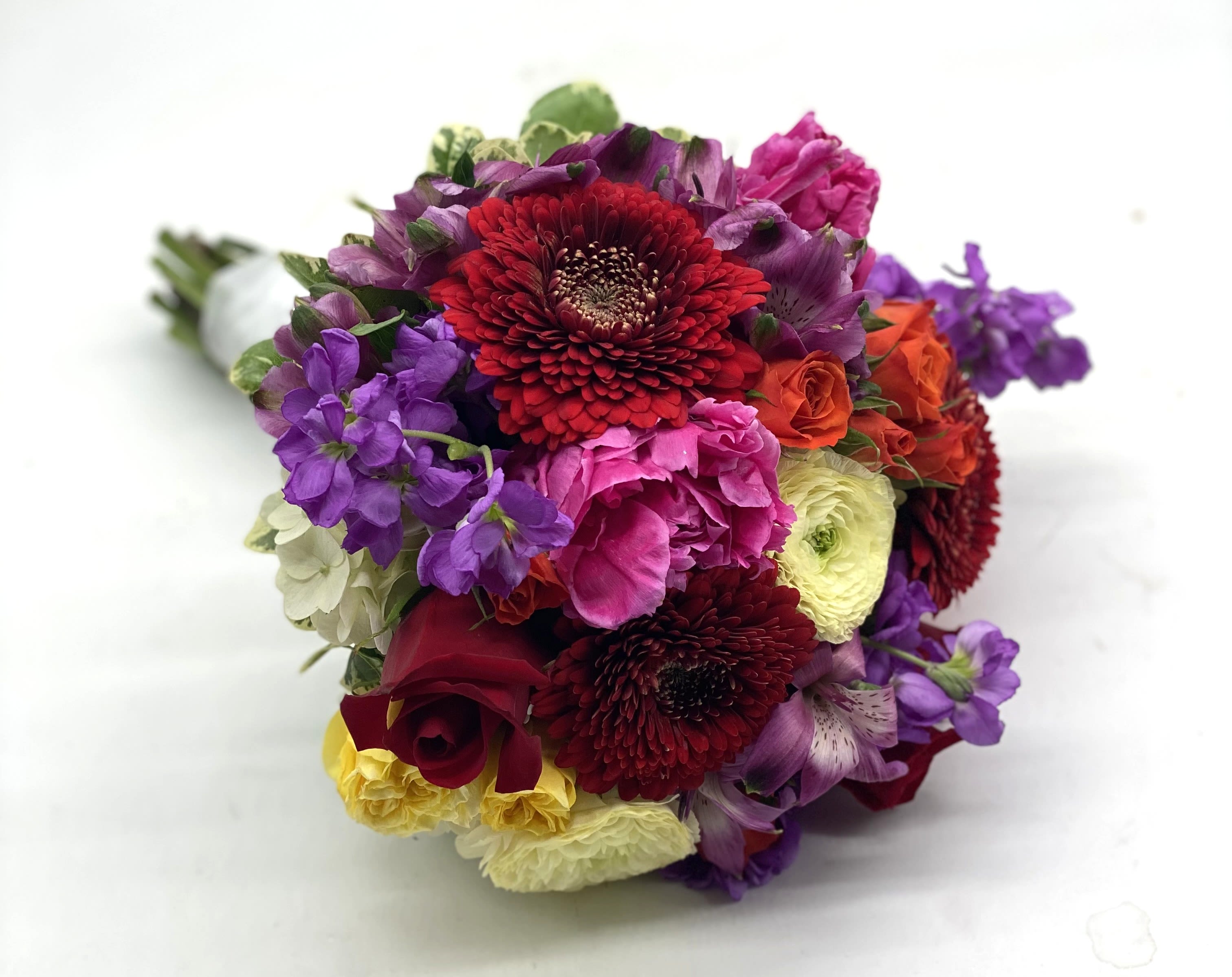 Fun &amp; Flirty Clutch Bouquet - A lush mix of red roses, pale yellow ranunculus, red gerbera daisies, purple stock and more!! 