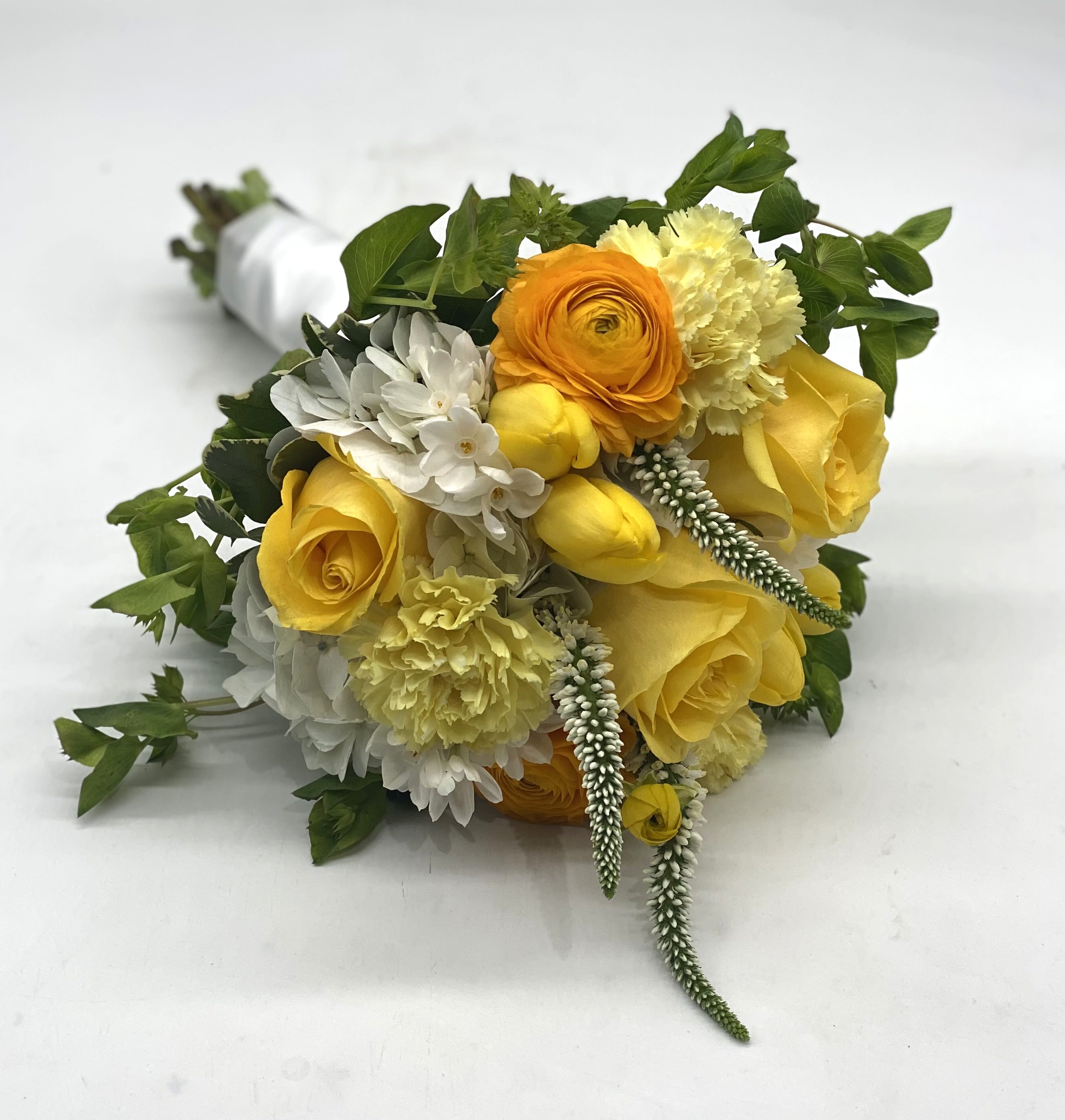 Sunshine Clutch Bouquet - A lush mix of yellow rose, tulips, ranunculus, carnations and more!
