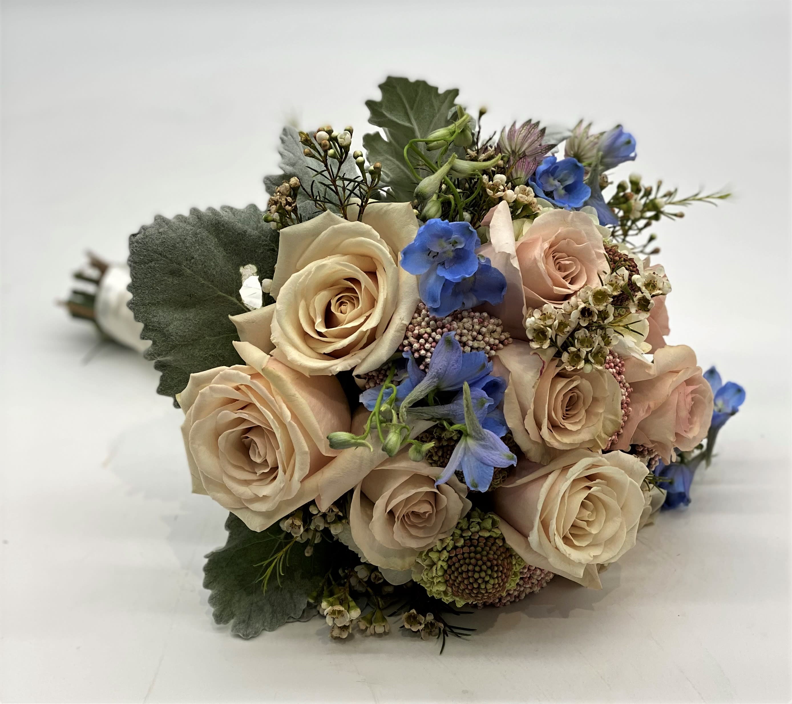 The Perfect Pastel Clutch Bouquet - The dusty coloring of this bouquet with the touch of pale blue really sets it apart!