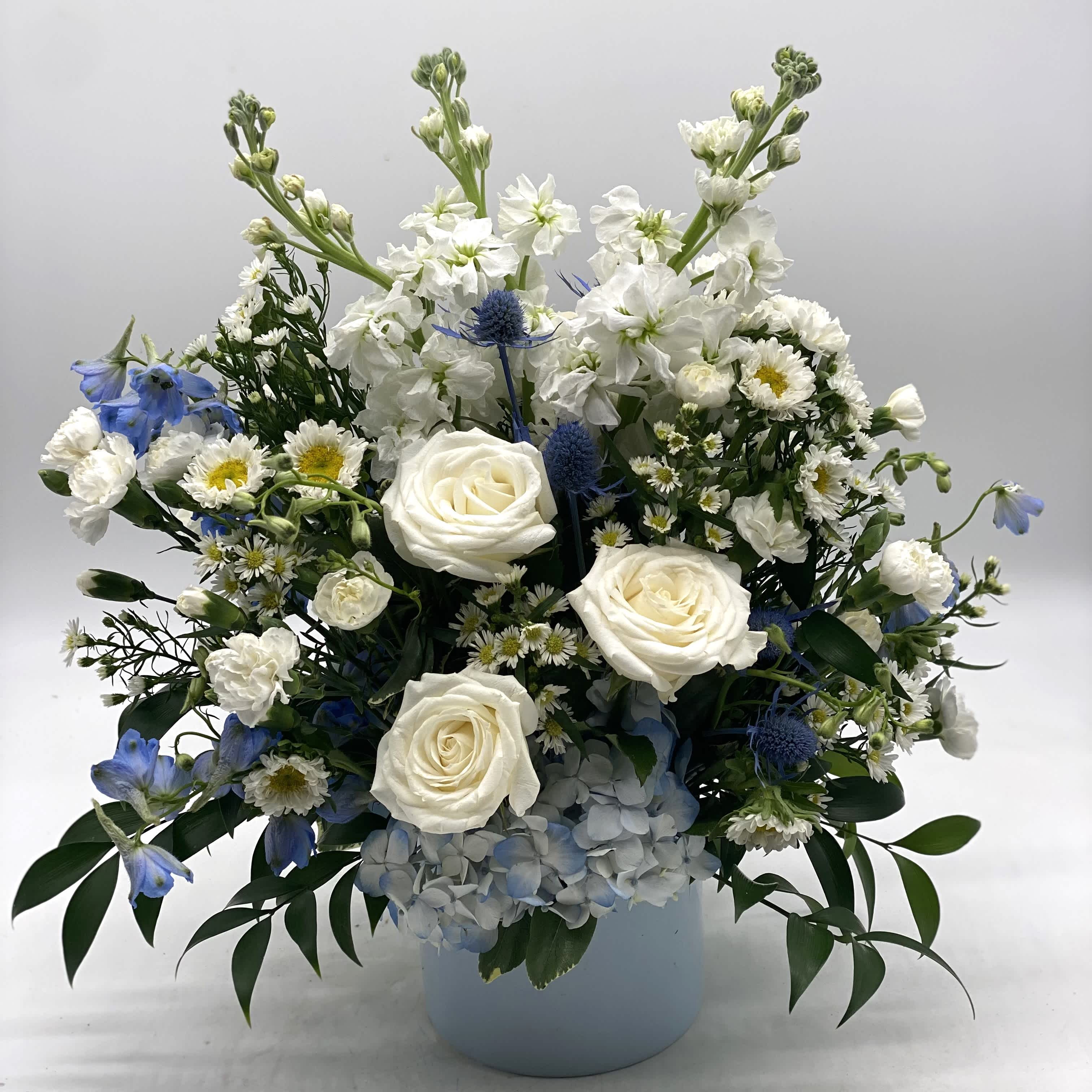 Blue Hues Bouquet - A mix of blue &amp; white blooms designed in a light blue ceramic container. Great choice to welcome that new baby boy into the world or for a nice, muted look for any occasion!