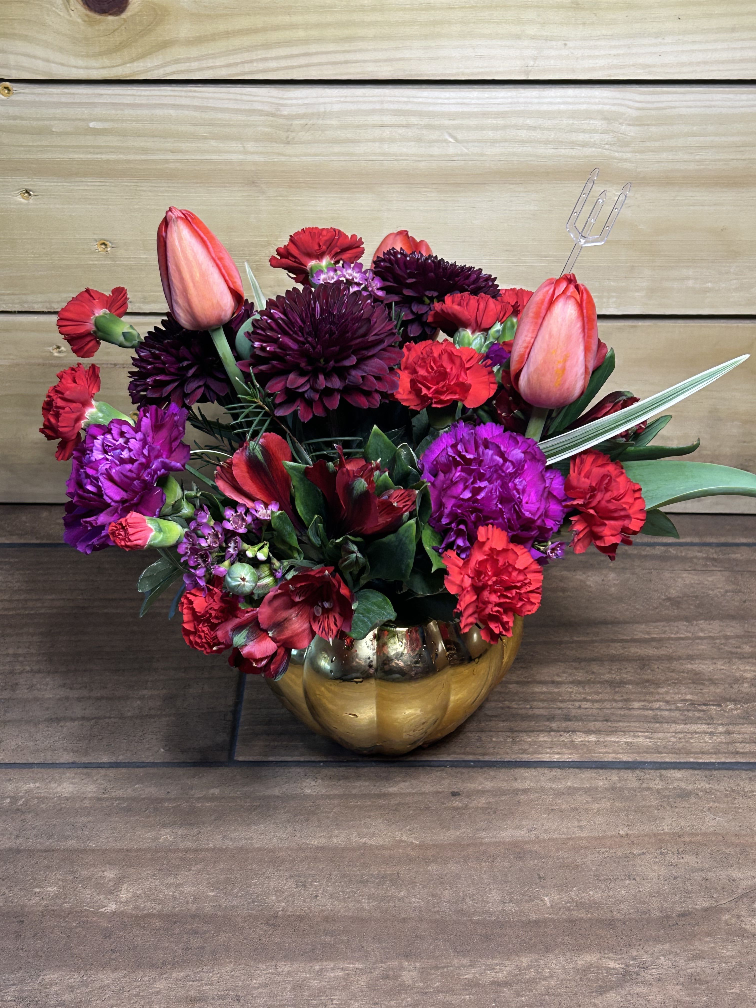 Crimson Romance - Bold, passionate, and full of rich color, Crimson Romance is designed to make a statement. This lush arrangement features vibrant red carnations, deep burgundy mums, striking tulips, and accents of magenta blooms, all gathered with fresh greenery in a shimmering gold keepsake container. The dramatic blend of reds and jewel tones creates a luxurious, romantic feel—perfect for anniversaries, date nights, Valentine’s celebrations, or any moment that calls for a little extra love.