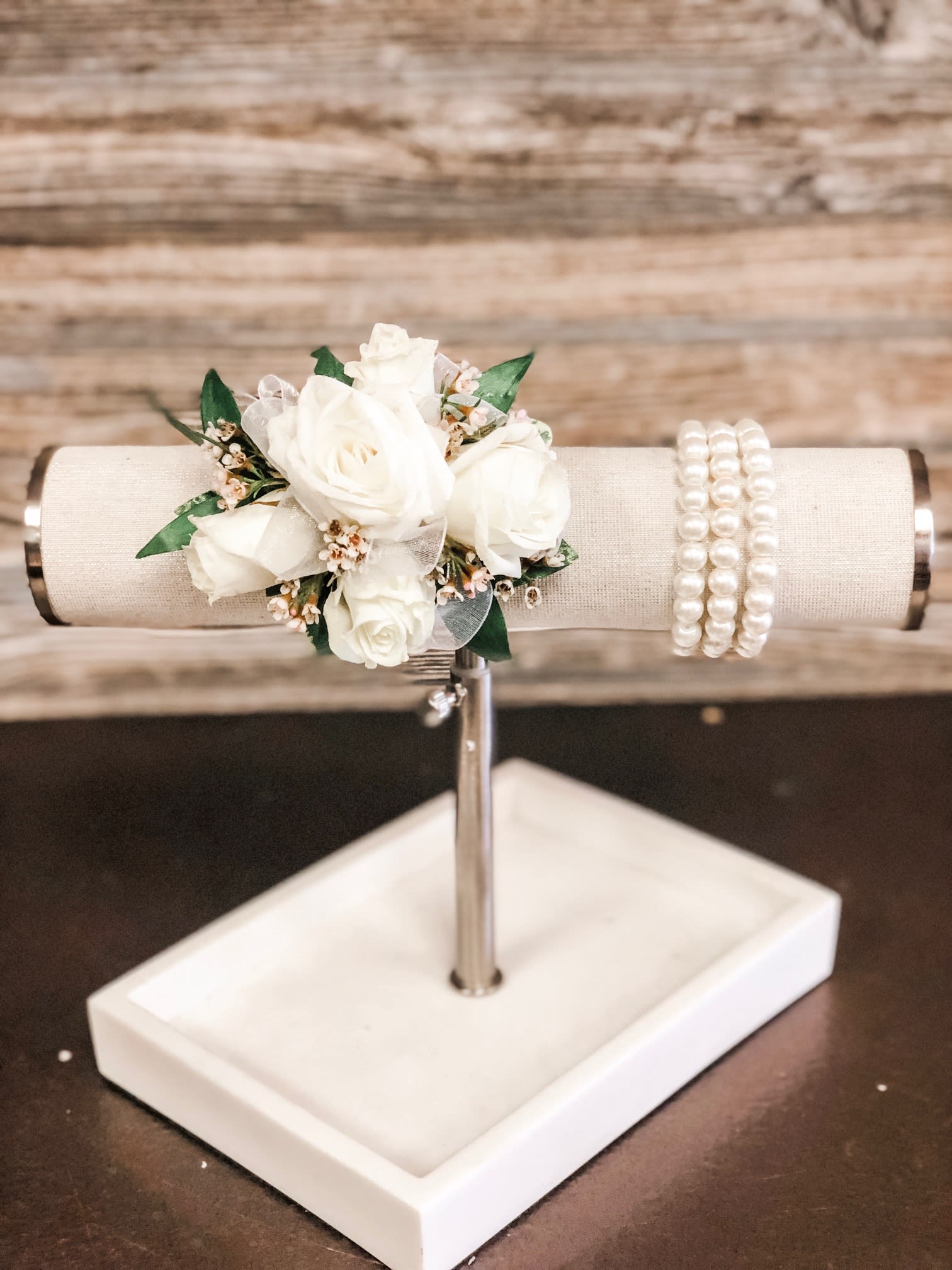 White Spray Rose Corsage with Upgraded Wristlet - White spray roses, sheer ribbon, white or light pink filler flower on a bed of greenery.  Wristlet and ribbon color can be customized.   Ribbon:  can match or compliment any dress color Wristels:  white, black, silver or gold faux pearl.  Also available Rhinestone.