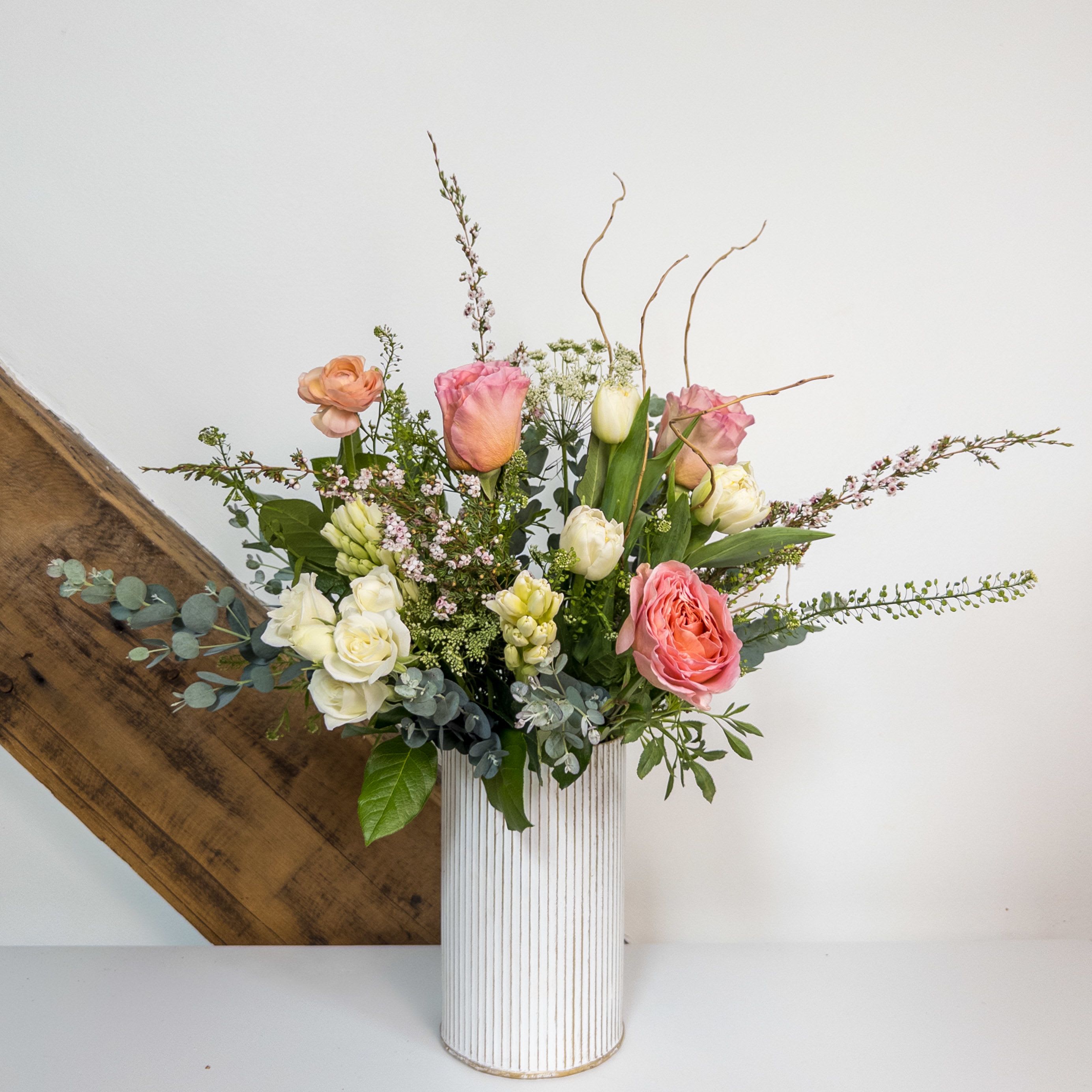 Meadow Waltz - Meadow Song is a soft and whimsical design of spring florals in shades of pink and white. The arrangement measures approximately 15x10 and can be upgraded to deluxe and premium for additional blooms.