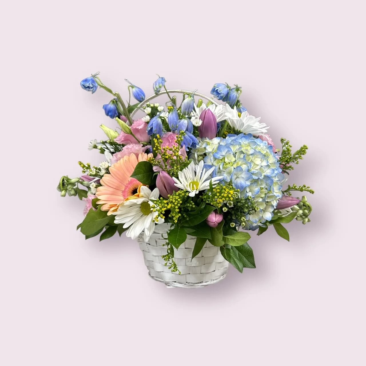 Bunny Basket Blooms  - Hippity Hoppity these blooms are a perfect way to say Happy Easter! A pastel mix of seasonal blooms in a charming wicker basket.