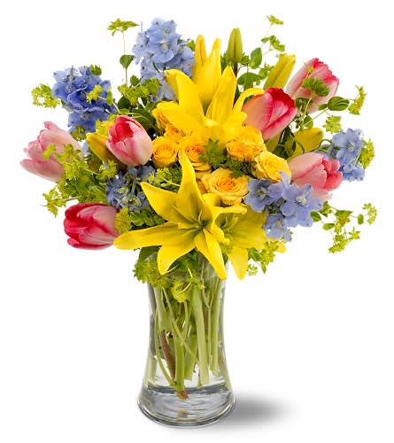 Spring Delight - Send all the joy of springtime, captured in a bright mix of yellow Asiatic lilies and roses, pink tulips and delphinium that are as blue as an April sky. It's a precious bouquet that will be received with great joy.     Yellow Asiatic lilies and spray roses, pink tulips and light blue delphinium, accented with bupleurum, are delivered in a clear glass gathering vase. Approximately 14" (W) x 16" (H) 