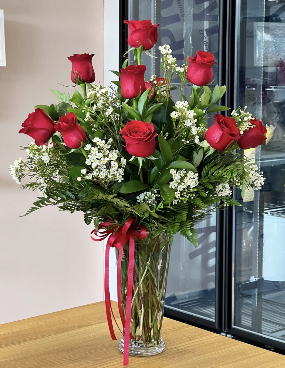 1 dozen roses - 1 dozen red roses with greens and filler flowers (filler will depend on availability )