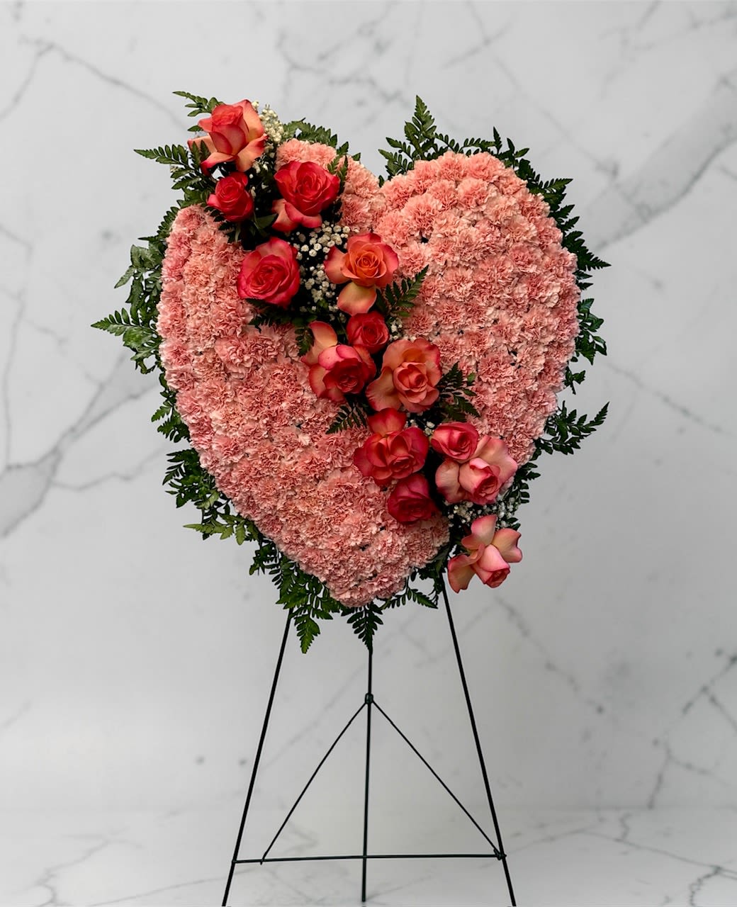 Pink Bleeding Heart - This is a variation of a bleeding heart that is all pink. It includes pink carnations and pink roses. 