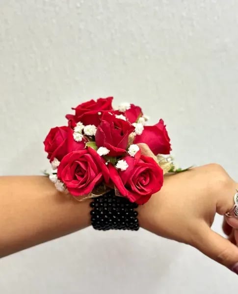 Bella Corsage - The Bella corsage has been made with love and passion with the bright red color and baby's breath on a elastic black synthetic pearls, perfect for your wedding or prom she will love it.