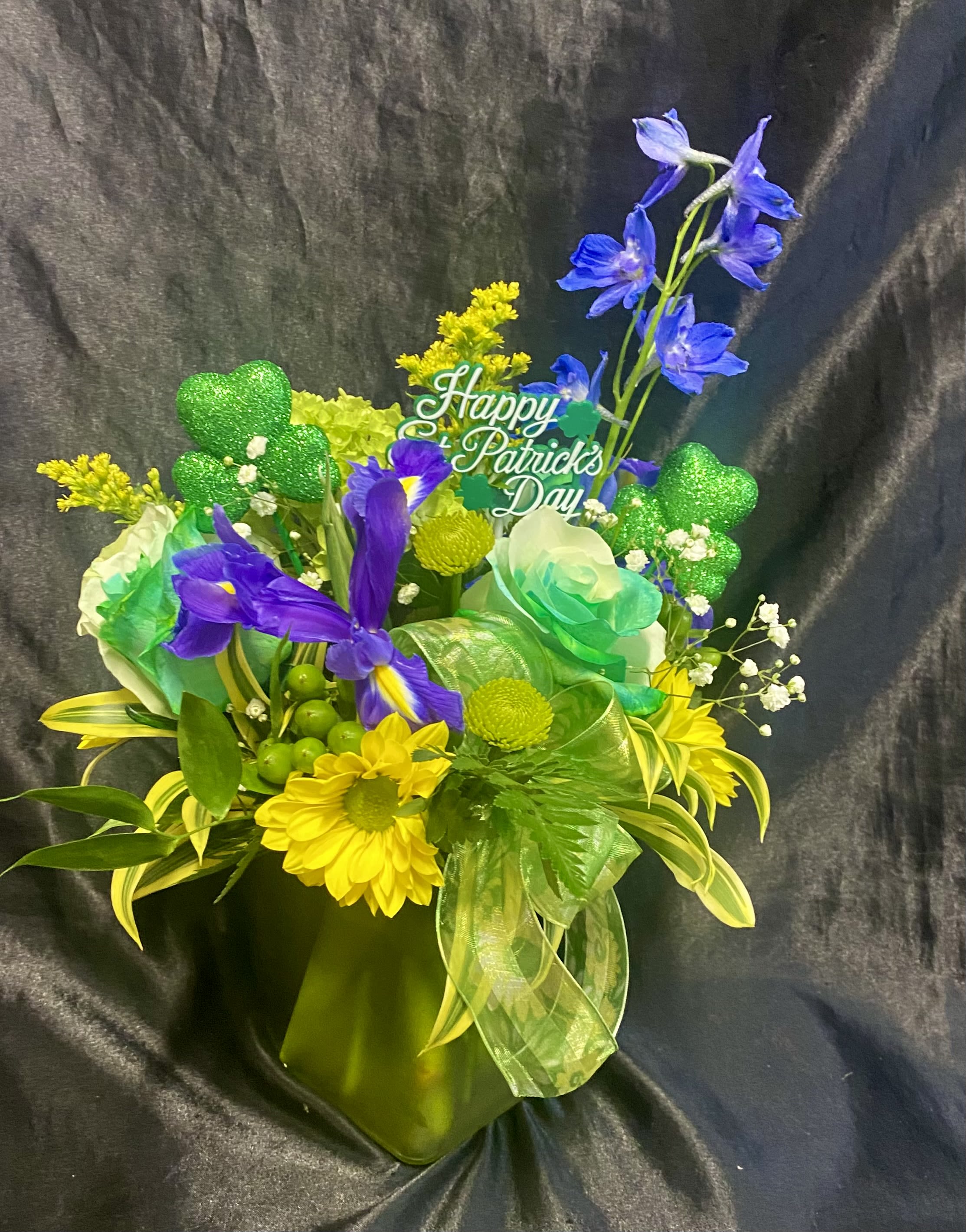 Small St. Patrick spring   For   “ One Day Only”  - Green themed.  With sunflower,  roses. blue delphinium etc    Shamrock accents. 