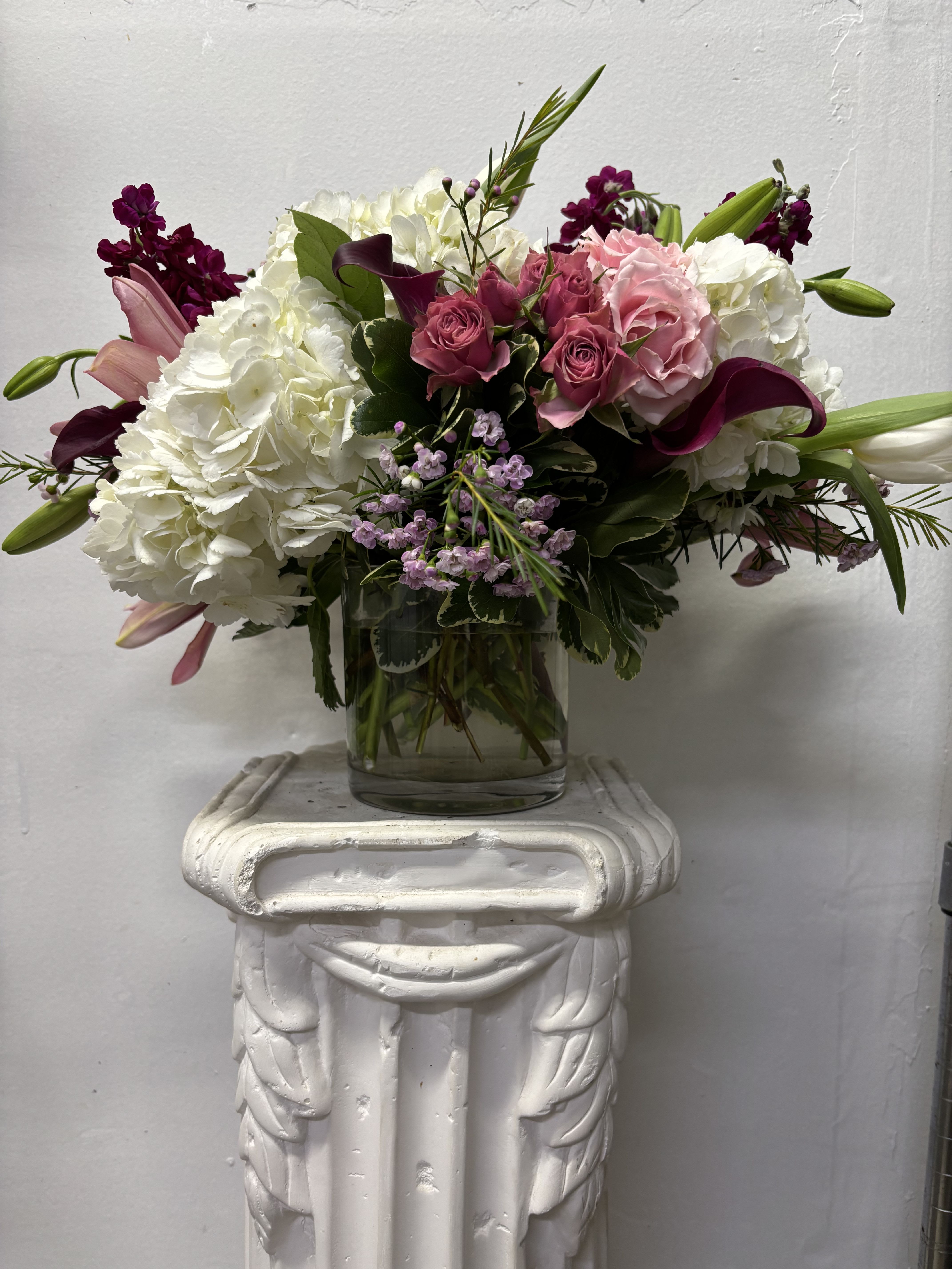 L'Amour - Pink roses with pink callas and lilies adorned with white hydrangeas and lavender wax flowers