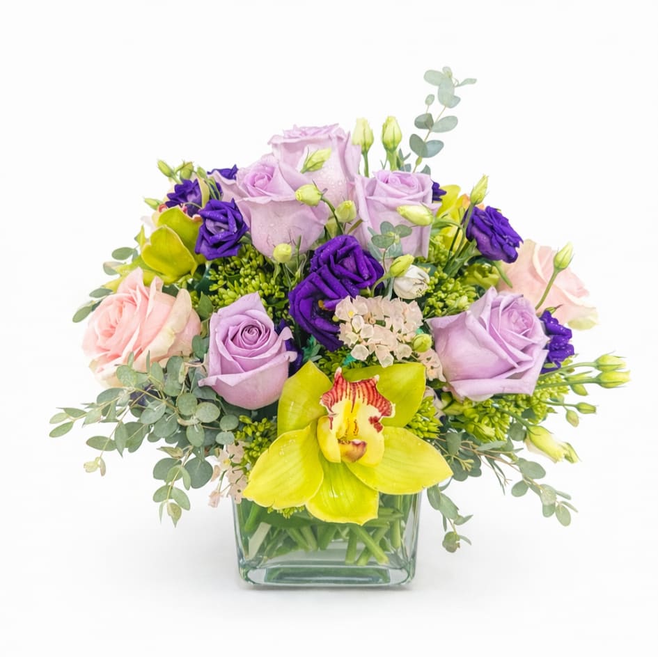 Lovely  Lavender Bouquet - Lavender Roses, Orchids, Ranunculus  with greenery in a rectangular vase