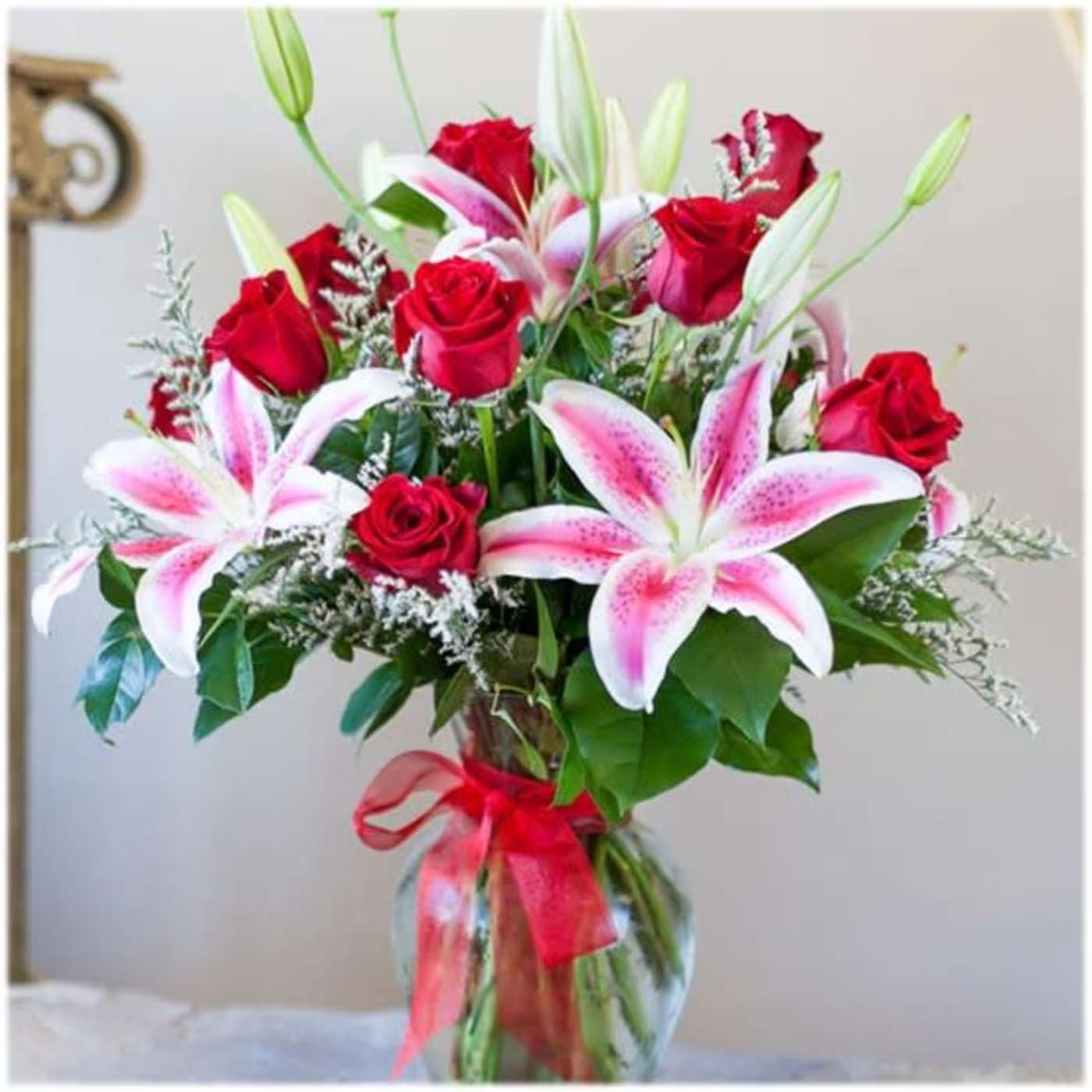 Love in Bloom  - Product Information A classic and always stunning combination of fragrant lilies and red roses - a perfect gift for anniversary, birthday or any other special celebration! Approximately 24"H  Standard  will include 9 Red Roses and 2 Pink Stargazers; Deluxe will include 12 Red Roses with 2 Pink Stargazers 