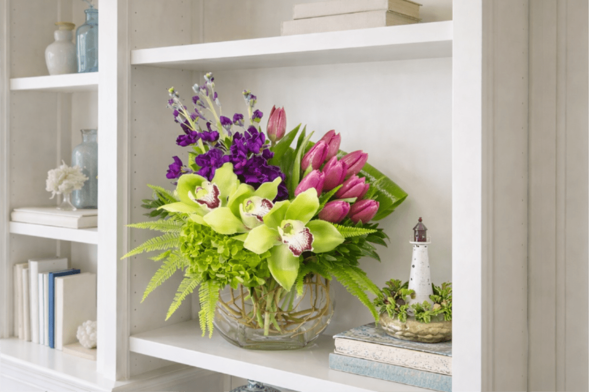 Contemporary Tulips - Contemporary tulips are design within a clear glass vase and the flowers included in this arrangement are Tulips. Stock, Hydrangea, Cymbidium, Umbrella Fern, and Rolled Ti.