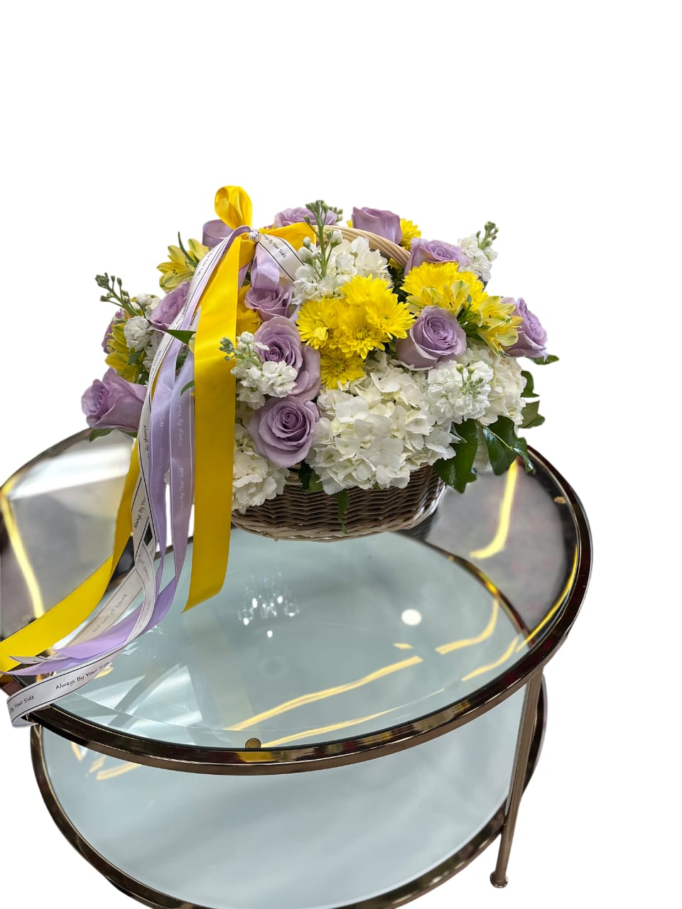 Lavender Glow - An elegant basket arrangement featuring yellow, lavender, and white flowers-a perfect blend of sunshine, softness, and spring beauty.