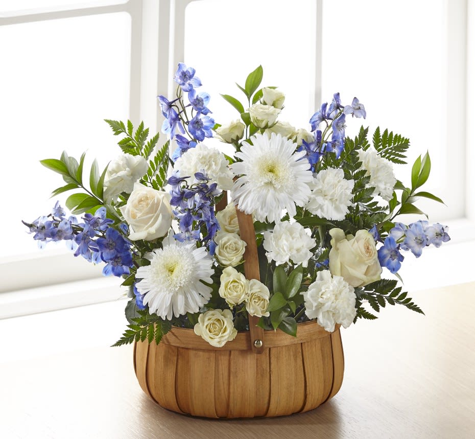 Harmony &amp; Grace Basket - Crafted with a modern mix of blooms, our Harmony &amp; Grace Basket shares peace, harmony and solace to a grieving loved one. The bouquet is crafted with an elegant collection of roses, delphinium and carnations, and it is your sentiment that truly brings this arrangement together. While this arrangement is effortlessly beautiful, it is best suited to be placed on a table or stand. 