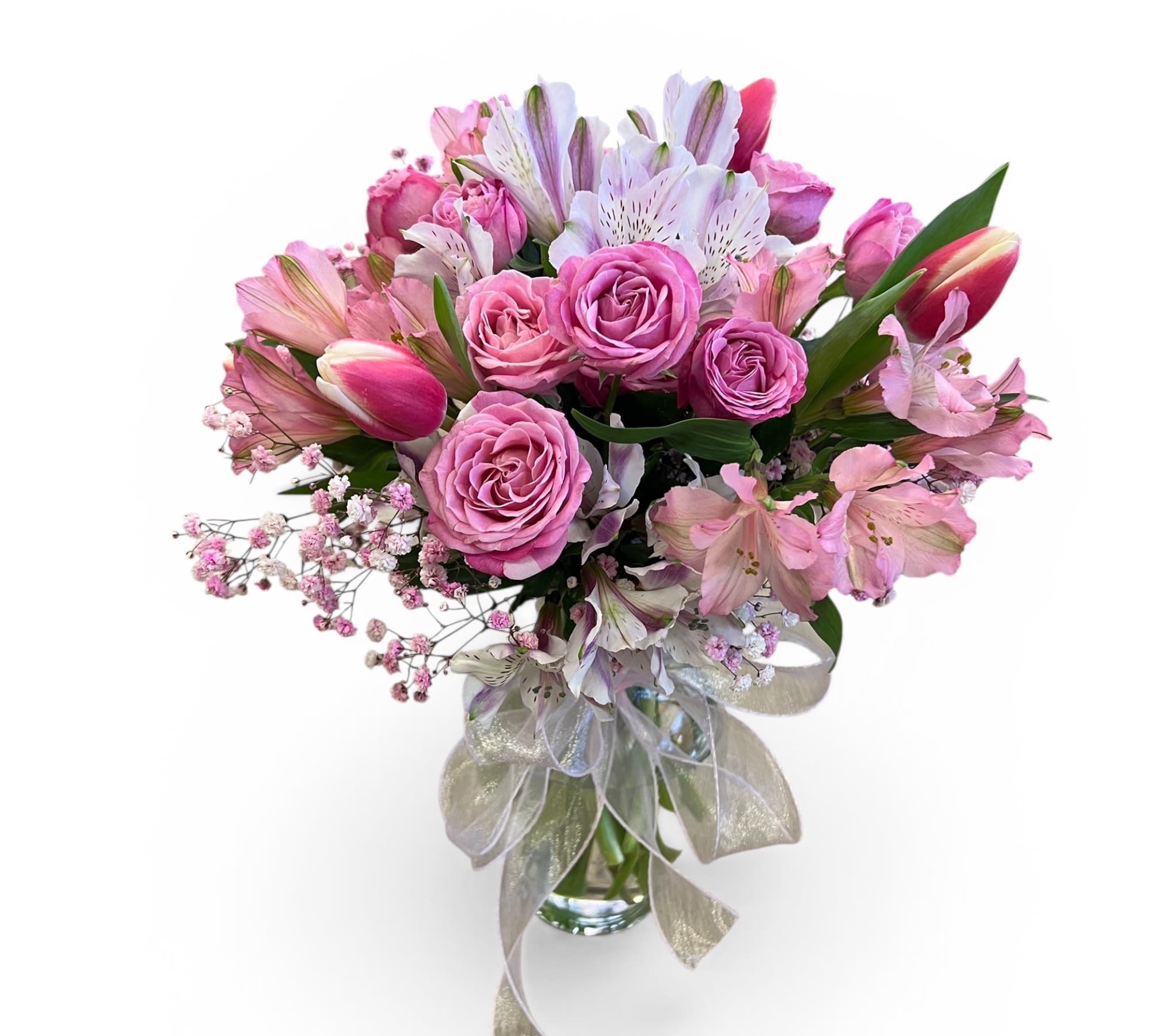Pink lady - Soft romance in full bloom   This elegant vase arrangement features lush pink roses, delicate tulips, charming alstroemeria, and airy sprays of baby’s breath — all beautifully gathered with fresh greenery and finished with a sheer ribbon bow.  Perfect for celebrating love, sweet moments, or simply brightening someone’s day with timeless pink beauty. 