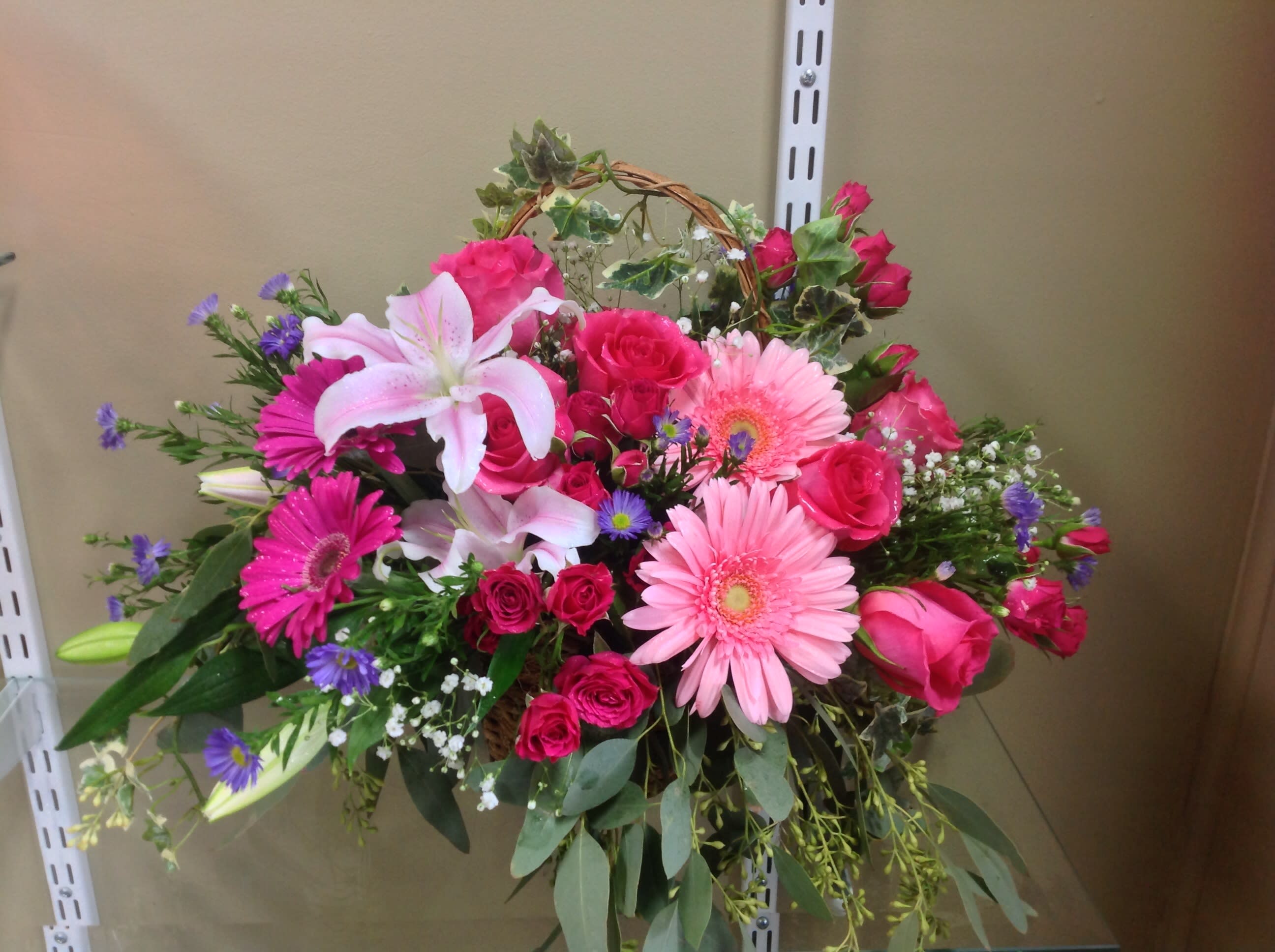 Bright cheer In a Basket - Bright colors of pink with fresh lilies, roses, gerbera daisy, spray roses
