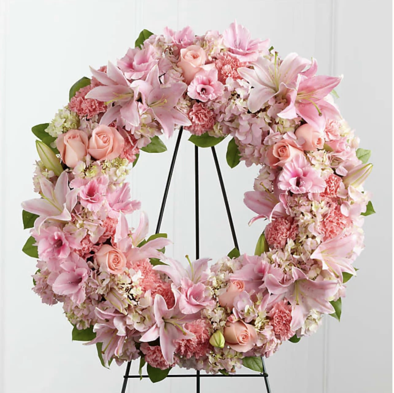 Eternal Grace Wreath - Eternal Grace Wreath | Wilmington, Delaware Florist  Honor a life filled with love and beauty with our Eternal Grace Wreath, a soft and elegant sympathy tribute handcrafted by Petals Flowers and Fine Gifts in Wilmington, Delaware. This delicate funeral wreath features light pink lilies, pale pink roses, and a lush mix of pink and white hydrangea, all thoughtfully arranged in a graceful circular design symbolizing eternal life and remembrance.  Perfect for funeral services, memorials, or graveside ceremonies, the Eternal Grace Wreath offers a serene and heartfelt way to express your condolences and celebrate a life well lived.  As your trusted local florist in Wilmington, Delaware, we provide same-day, tax-free delivery to funeral homes and memorial services throughout Wilmington, Hockessin, Newark, Chadds Ford, Glen Mills, Kennett Square, and nearby communities.  Why Choose Us? * Elegant, custom funeral wreaths with a satisfaction guarantee * Locally owned florist in North Wilmington * Compassionate service and premium, fresh blooms  Send a message of love, peace, and lasting tribute with the Eternal Grace Wreath, expertly designed and delivered by your local Wilmington florist.