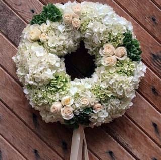 Soothing Wreath - Soothing Wreath | Wilmington, Delaware Funeral Flowers Offer peace, comfort, and grace with our Soothing Wreath, a soft and elegant funeral arrangement handcrafted by Petals Flowers and Fine Gifts in Wilmington, Delaware. This beautiful standing wreath features lush white and green hydrangea, pale blush roses, and a delicate blush ribbon—creating a timeless expression of sympathy for a funeral, memorial service, or celebration of life.  The Soothing Wreath is a gentle tribute that conveys serenity, love, and remembrance. Its neutral and blush-toned palette brings a calming presence to any service, while the circular design symbolizes eternal love and unending support during times of loss.  As your trusted local florist in Wilmington, Delaware, Petals Flowers and Fine Gifts specializes in premium sympathy flowers thoughtfully arranged with care and compassion. We offer same-day, tax-free flower delivery to all local funeral homes, churches, and residences throughout Wilmington, Hockessin, Newark, Chadds Ford, Glen Mills, Kennett Square, and nearby areas.  Why Choose Petals Flowers and Fine Gifts?  * Elegant, custom funeral and sympathy flower designs * Locally owned florist in North Wilmington with personal, caring service * Same-day, tax-free delivery throughout the greater Wilmington area Send the Soothing Wreath today and share your heartfelt condolences with a soft, elegant floral tribute that brings beauty and peace to those who need it most.