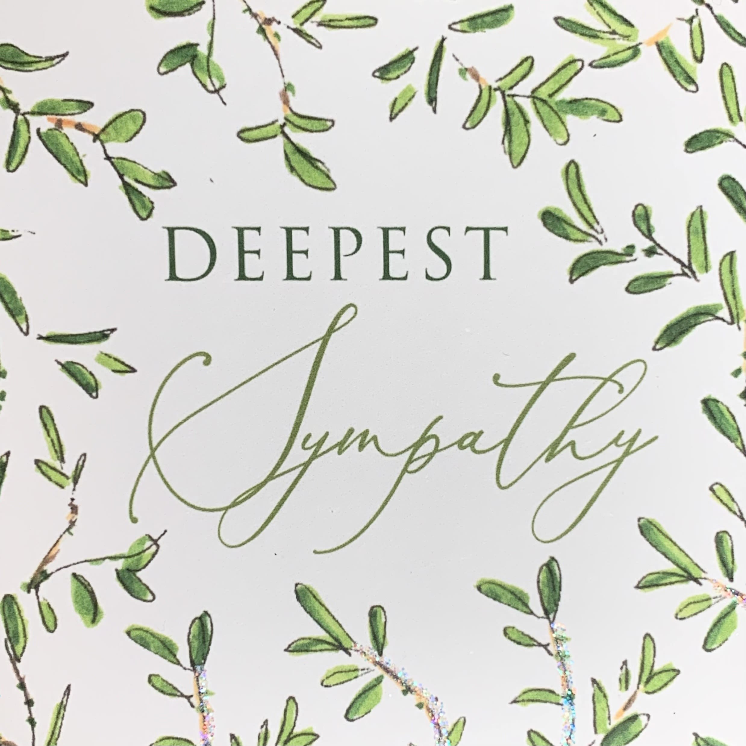 Sympathy card with green leafy border and the words Deepest Sympathy in script