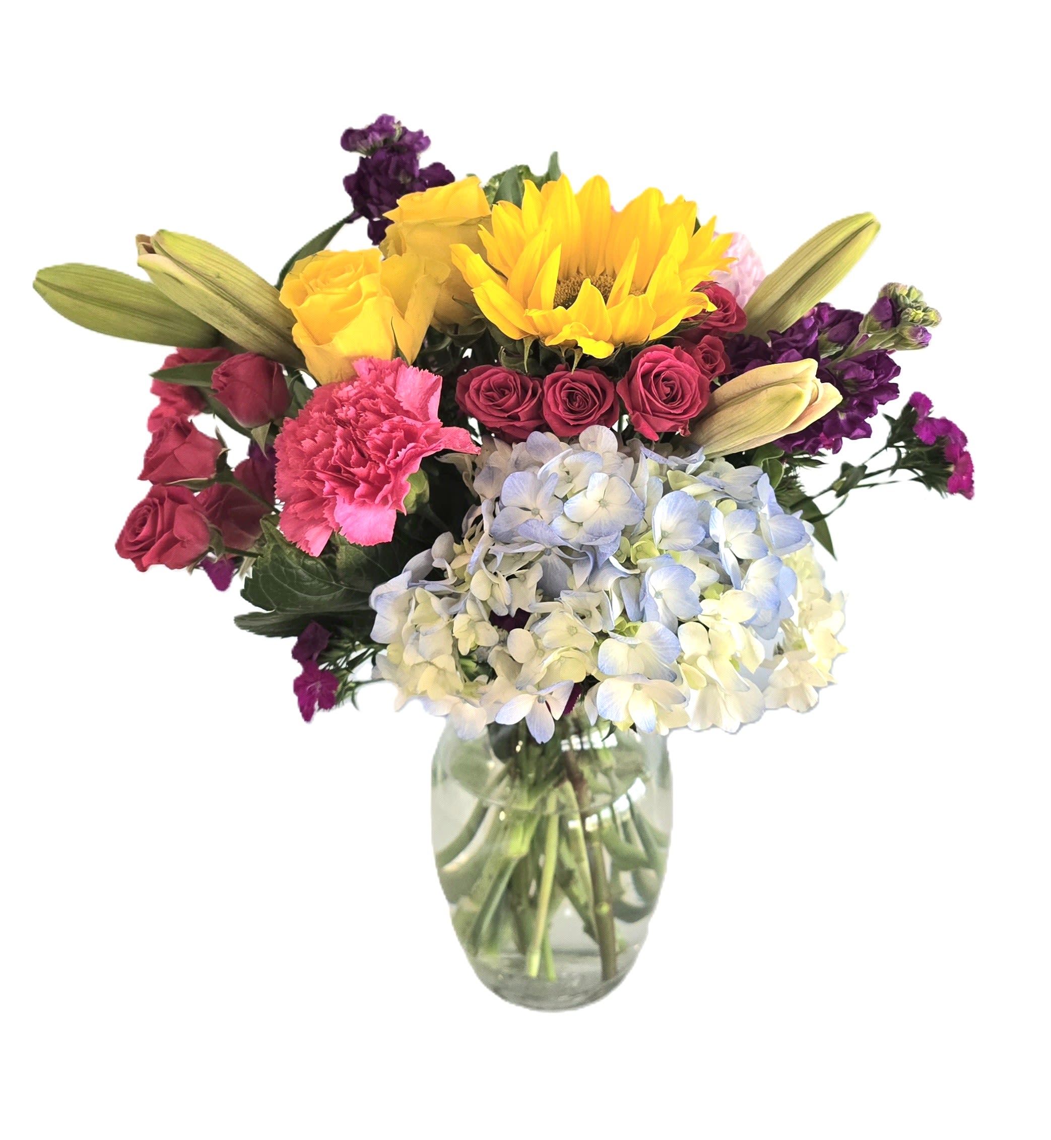 Best Wishes  - A colorful mixed bouquet featuring an array of focal flowers like, rose, hydrangea, sweet prince William, lilies, carnations, spray roses, sunflower, larkspur &amp; greens set in a clear glass vase. Perfect for any special occasion.   Measures approx. 14" tall &amp; 12" wide Orientation: All around