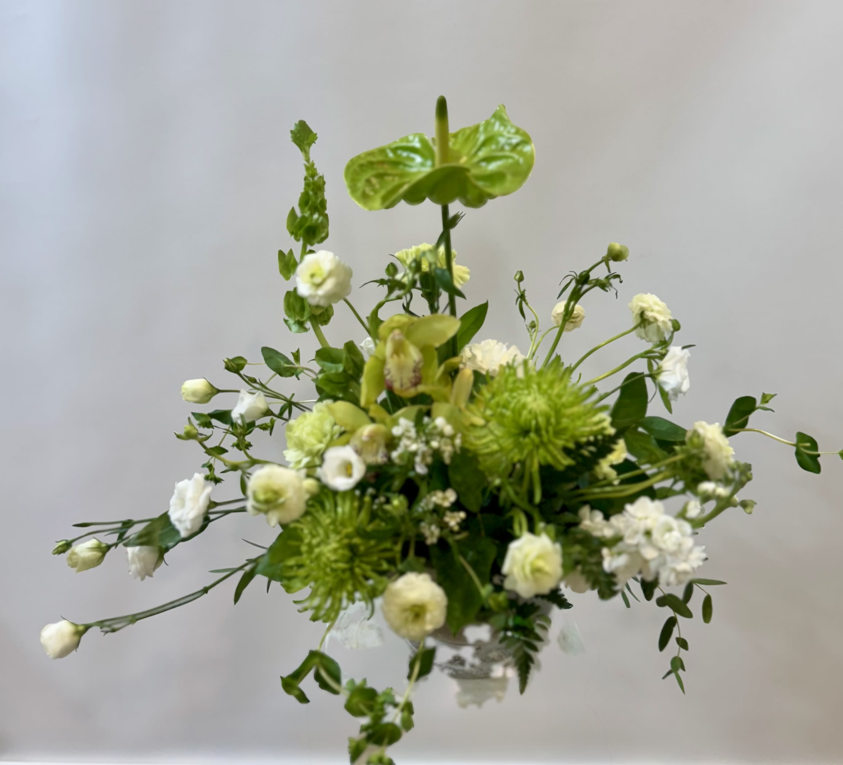 Evergreen Lush Bouquet - Mums, Lisianthus,  Anthurium with greens in a vase 