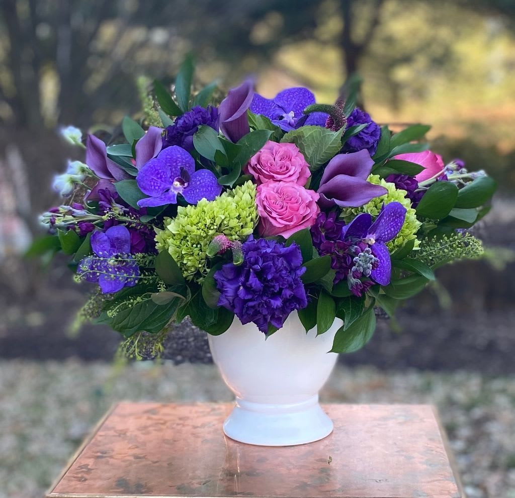 Purple Kabloom - This purple arrangement is blooming with purple garden roses, purple lizzy, purple orchids and deep purple calla lilies.  It is accented by fancy green hydrangea, pink veronica and delicate pepper grass.  Tax free. Same day hand delivery.