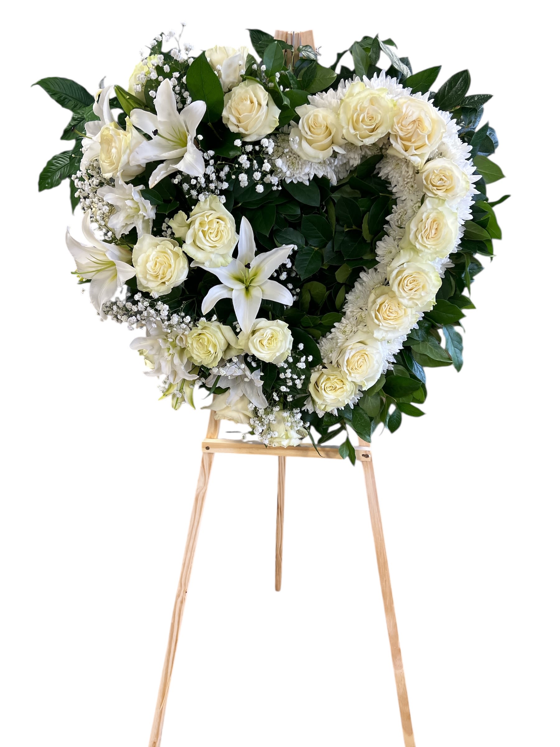 Heart shaped funeral arrangement - White roses, lilies, and baby's breath arranged in a heart shape with green leaves. We could change any color that you like !