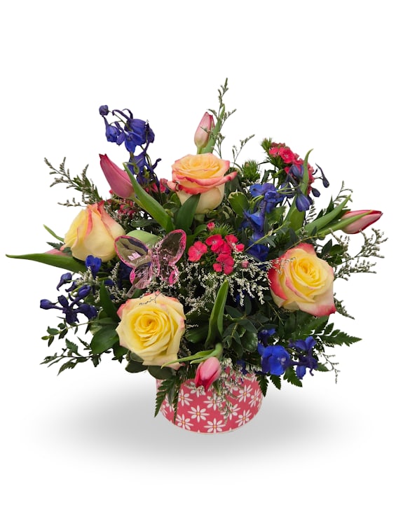 Joyful Blooms - Select this bold and beautiful arrangement featuring vibrant roses, pops of blue and pink blooms, and lush greenery for a lively, eye-catching design. Finished with a keepsake butterfly stake (color will vary).  Approx. 17" x 12" x 12"