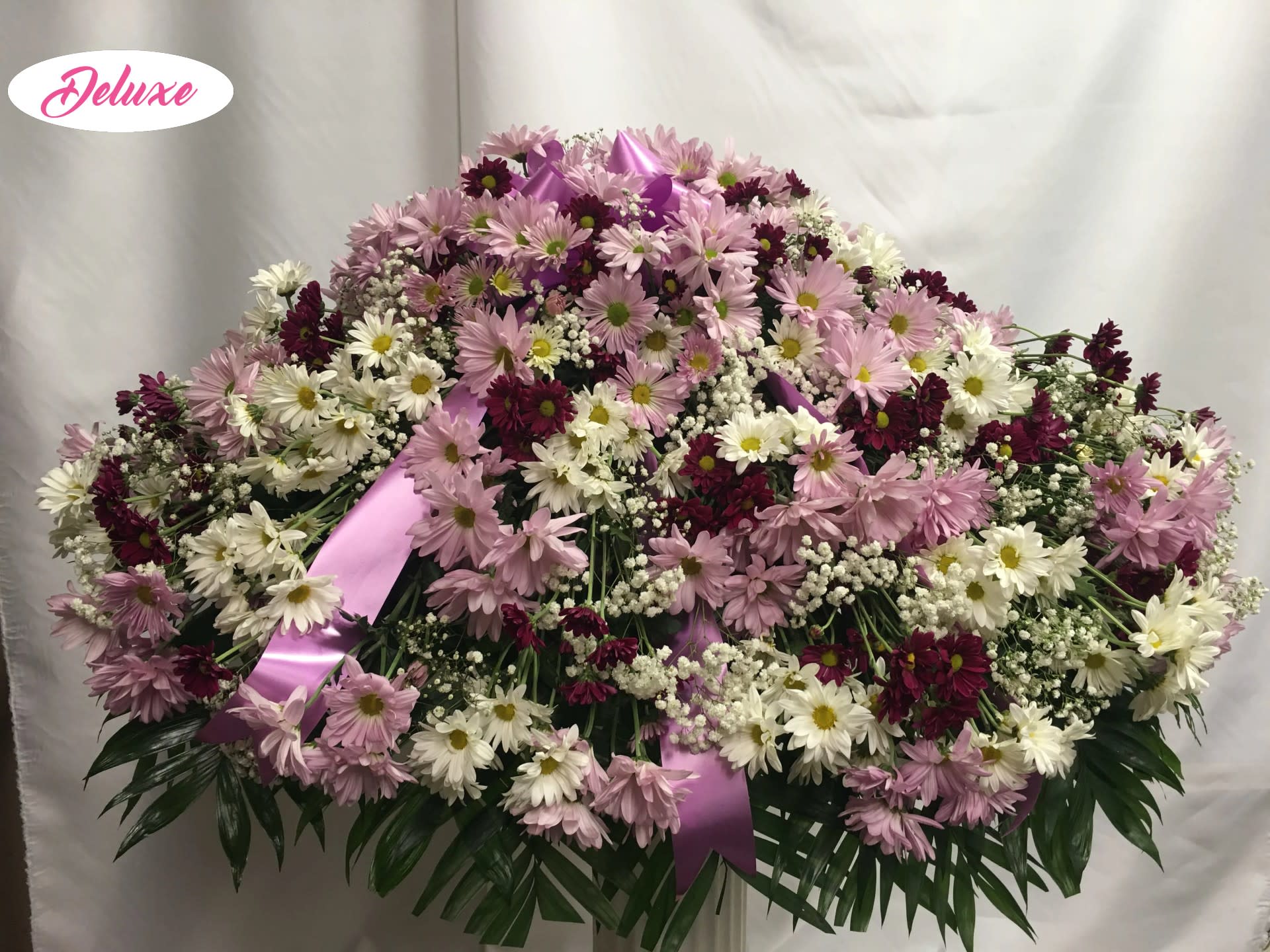 Daisys Cover  - This casket cover is lovely. Made up of all white, lavender and purple daisys it is a beautiful garden look. Colors can be changed for preference. 