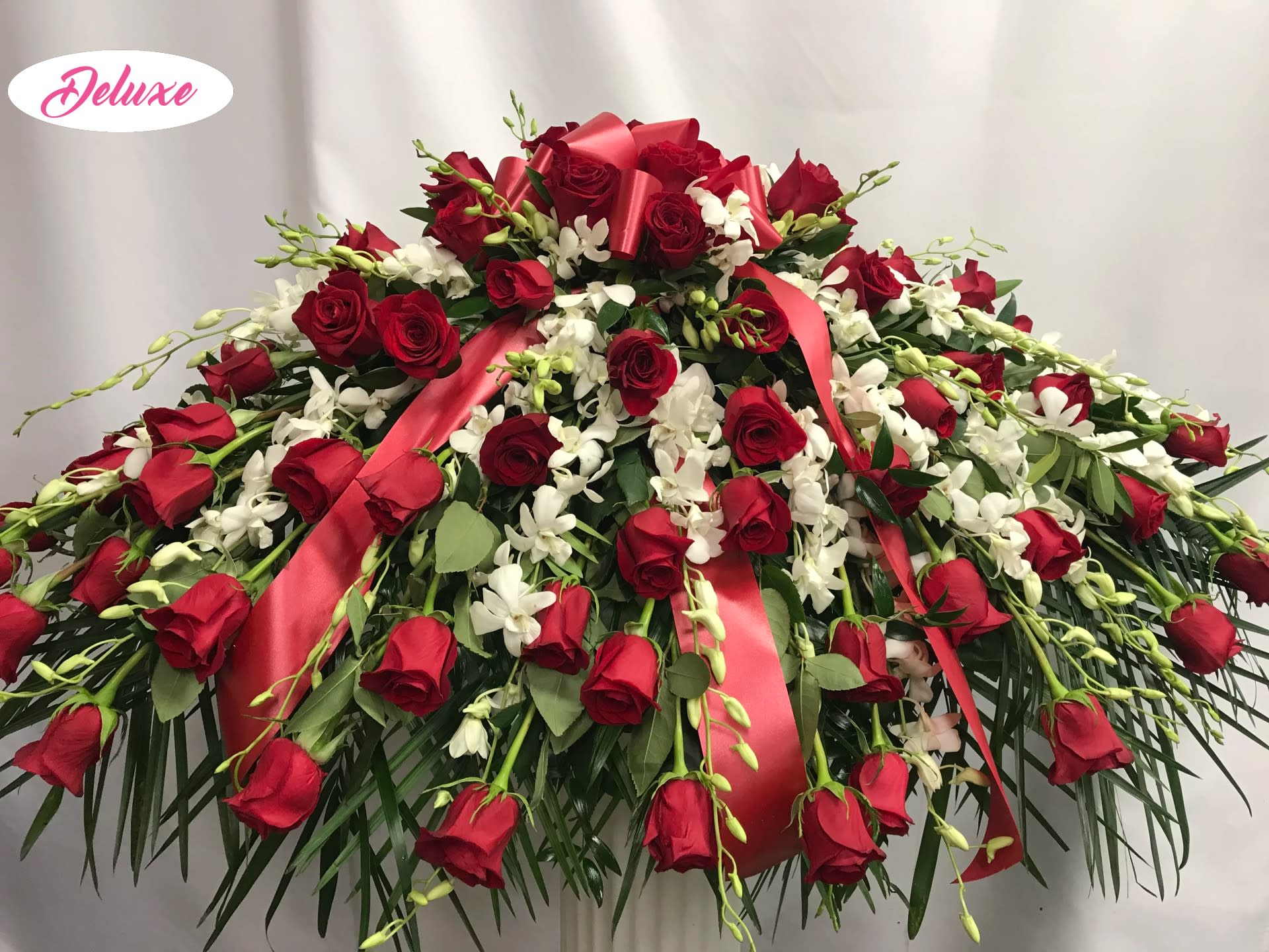 Forever in our Hearts - A beautiful color combination always. Red and white is a traditional and yet elegant combination. Roses and orchids are a very high end design &amp; lovely for any loved one. 