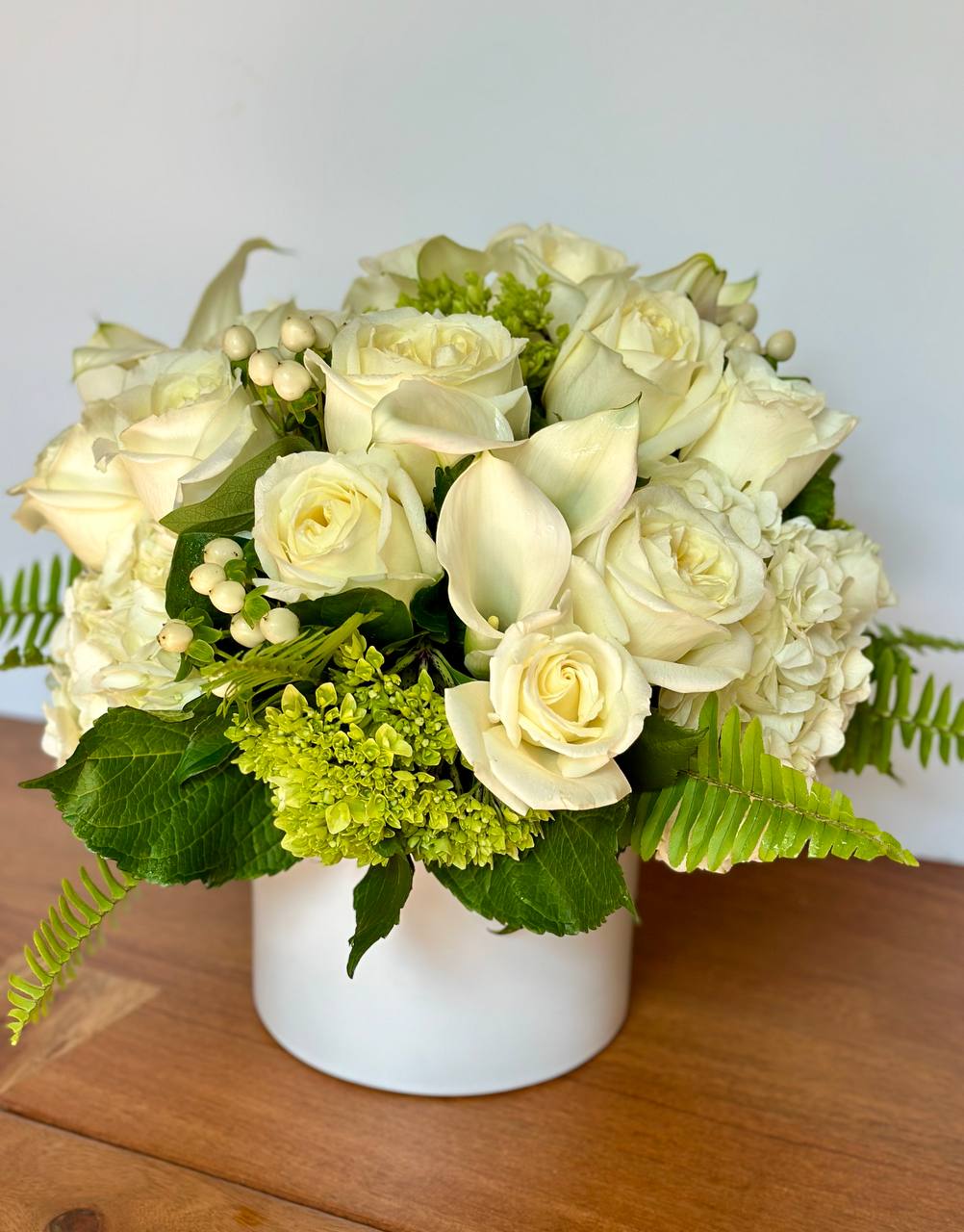 Dove - Let your love shine! No matter the recipient or the occasion, this stunning monochromatic mix of hydrangea, roses, and mini calla lily is hand-delivered in a shimmering white ceramic vase.