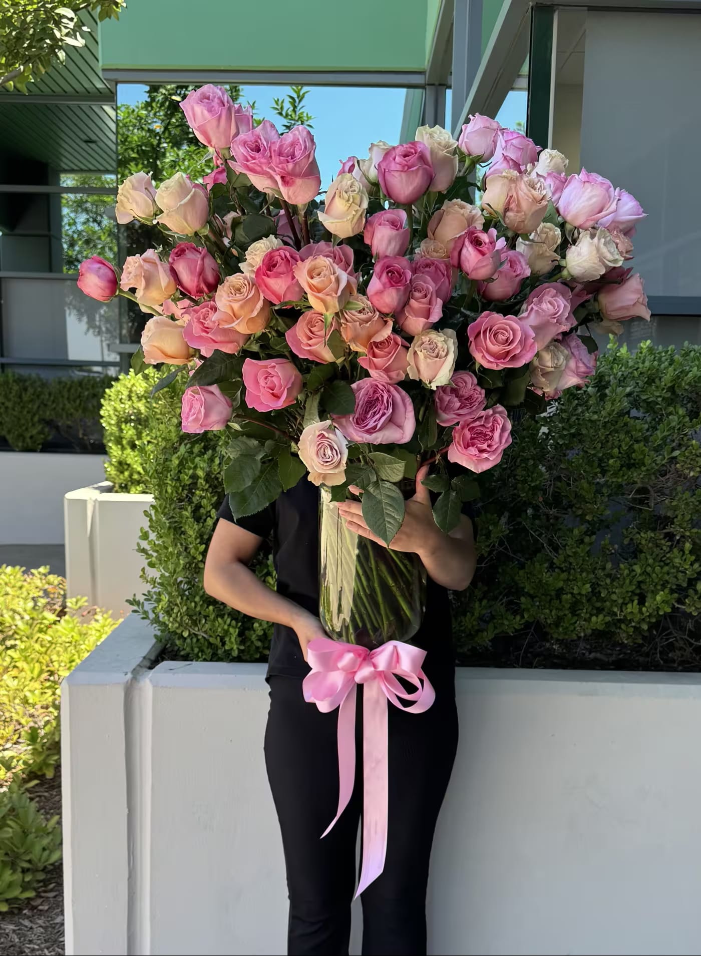 100 Pink Roses - Make a lasting impression with this stunning arrangement of 100 premium long-stem pink roses, expertly designed by Flower Synergy. Each rose is carefully selected for its soft blush to vibrant pink hues, lush petals, and superior quality, creating an elegant and refined expression of beauty and grace.  Featuring extra-long stems measuring approximately 34 inches in height, this luxurious pink rose arrangement offers a dramatic, full presentation ideal for birthdays, anniversaries, celebrations of love, gratitude, and milestone moments. Hand-arranged by our skilled florists, these premium pink roses are crafted to highlight their natural charm and deliver exceptional visual impact.  This classic pink rose arrangement is perfect for those seeking luxury flowers, long-stem roses, and high-end floral design in Orange County. Whether you are celebrating a special occasion or sending a meaningful gesture of admiration and affection, these 100 long-stem pink roses are designed to impress and delight.
