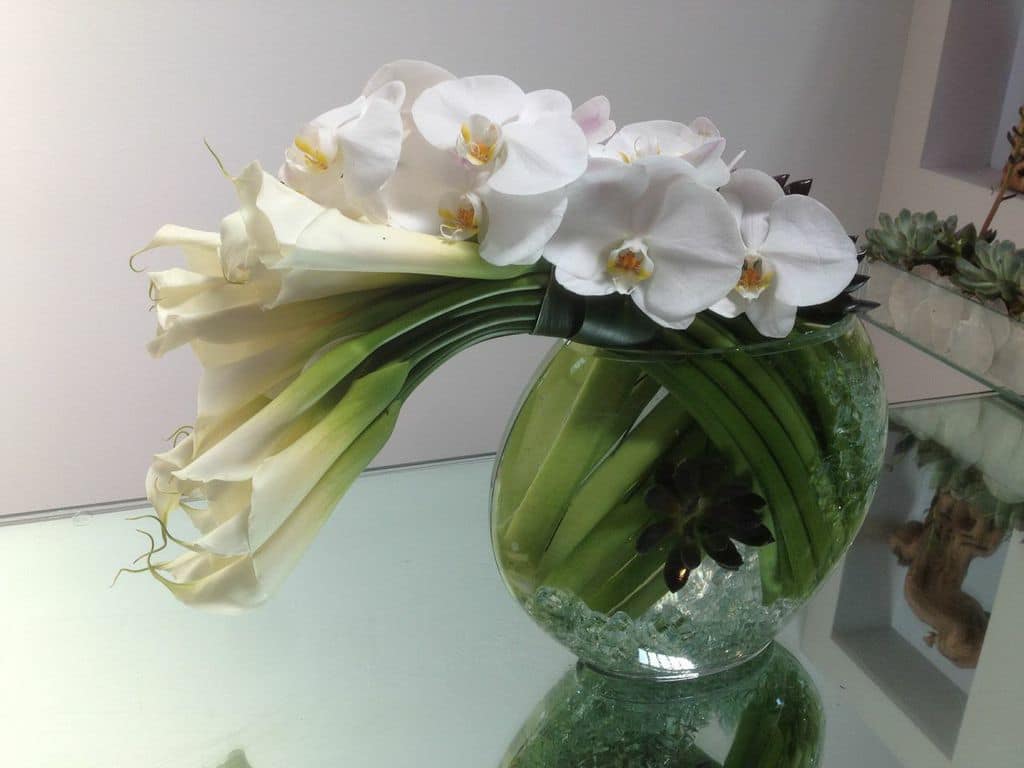 Bended - A medium-sized moon vase full of large Calla Lilies and adorned with beautiful white Phalaenopsis Orchids is the perfect chic and modern statement for any occasion!