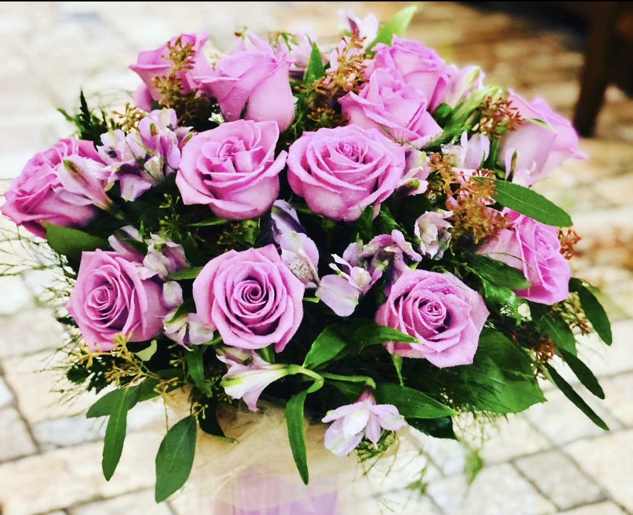 Dozen Pink Rose Bouquet  - Dozen Pink Rose Bouquet Soft, elegant, and full of charm, this classic bouquet features twelve premium pink roses nestled in fresh greenery. Pink roses symbolize admiration, gratitude, and sweet affection, making this arrangement a beautiful choice for celebrating love, friendship, or simply brightening someone’s day. Hand-tied and thoughtfully wrapped, this bouquet delivers timeless beauty with a gentle, romantic touch—perfect for birthdays, anniversaries, or just because. 