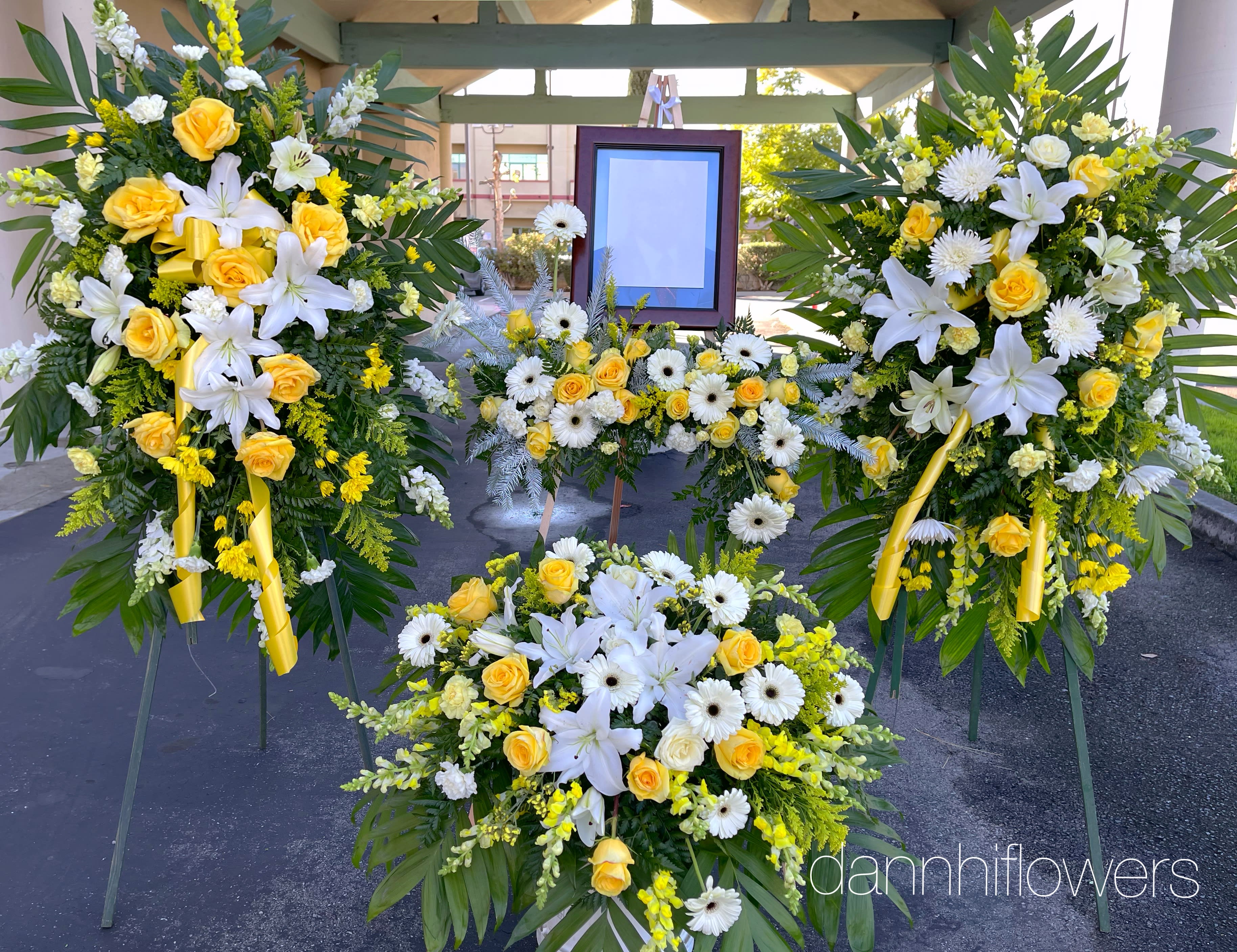 Sympathy package 01 - 2 standard standing spray, 1picture frame flowers, 1 casket top flowers. Customer can request any color theme for this package. Picture show at standard size. The deluxe and premium package will have more flowers and bigger size. Please call and discuss your choice of colors or flowers.