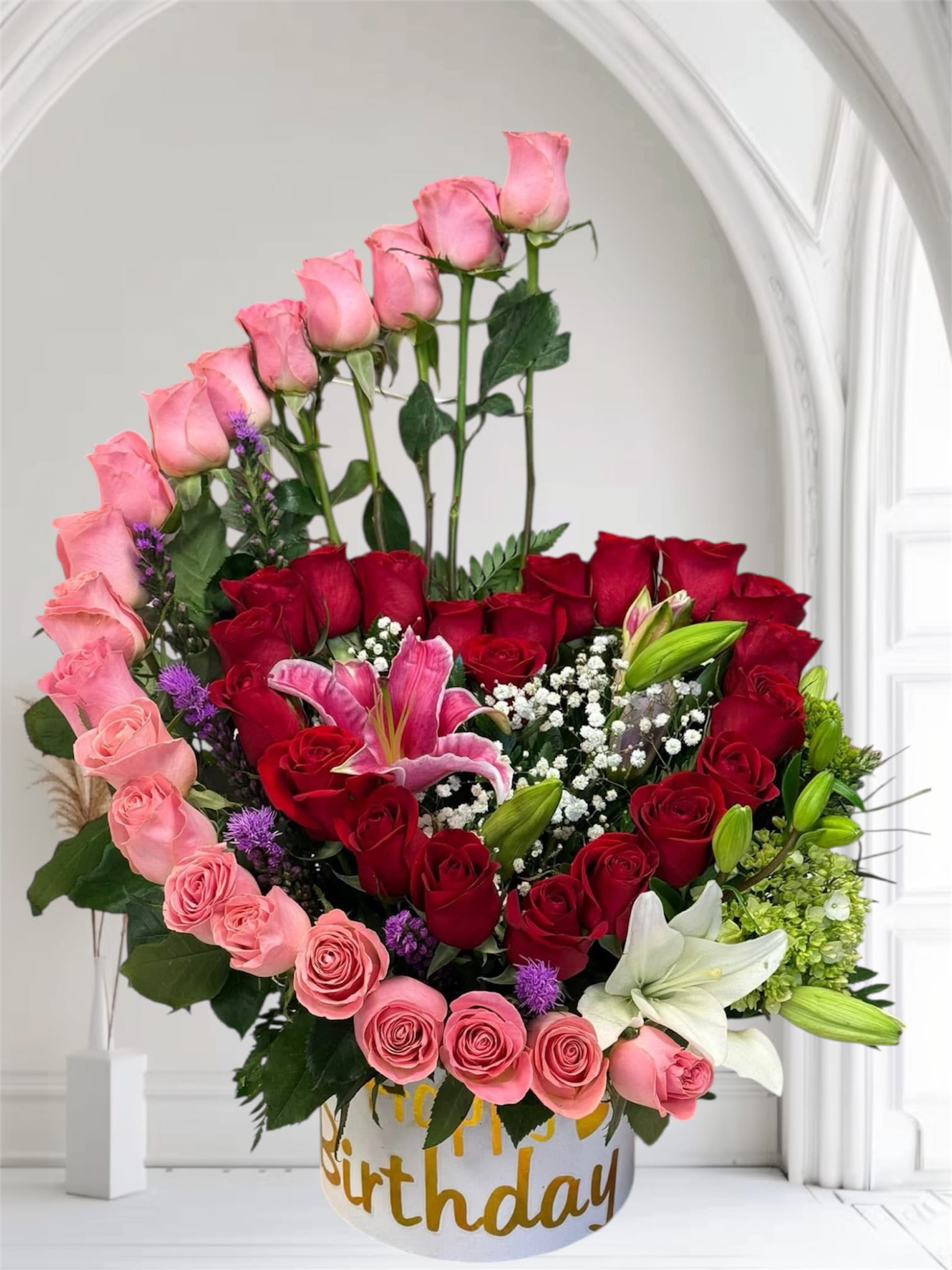 Mixed bouquet of pink and red roses with lilies in a birthday box