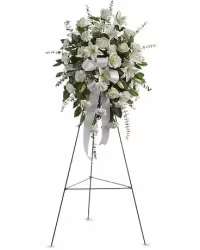 Pure White Standing Spray - A timeless and elegant all-white standing spray, beautifully arranged to express peace, love, and heartfelt sympathy. This classic tribute features a harmonious blend of pristine white roses, soft white carnations, and graceful white lilies, creating a full and serene display. Accented with lush fresh greens for natural depth and contrast, the arrangement is finished with a coordinating white bow, offering a refined and respectful expression of remembrance.