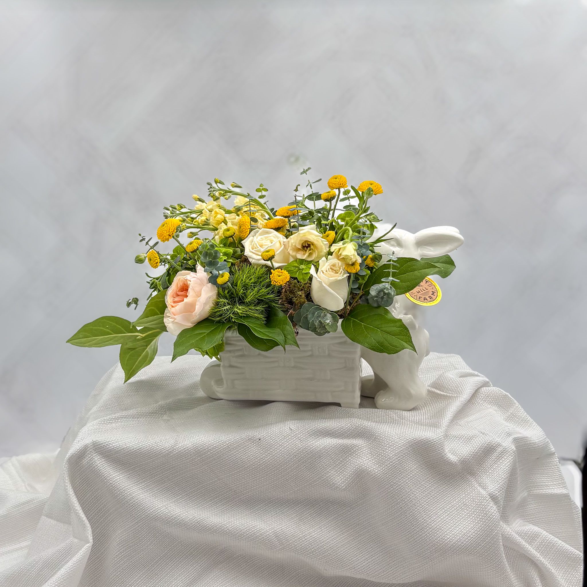 Easter Garden Party (Limited) - Spring blooms in an adorable Easter Bunny with wagon ceramic keepsake container. Make it a complete gift by adding one of our chocolate or candle cross sells, or select something from our Thoughtful gift selections. A 