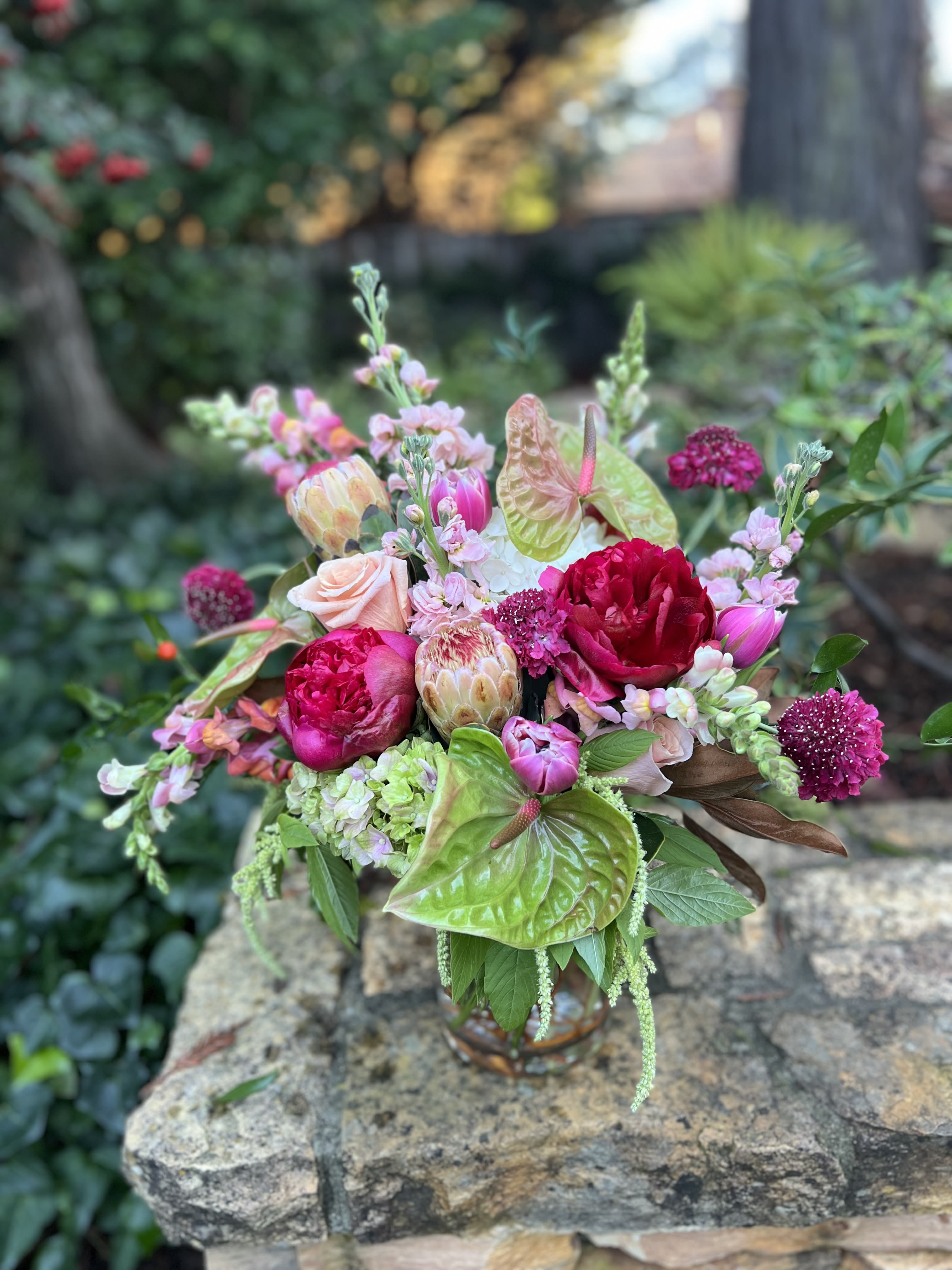 Mixed bouquet in a glass vase with pink and green blooms