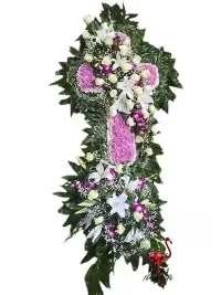 Lavender Serenity Two-Tier Standing Spray - An elegant and sophisticated two-tier standing spray designed to convey peace and reverence. The top tier features a beautifully crafted cross of soft lavender cushion mums, with a cross break of fresh greens accented by pristine white roses and graceful lilies. The second tier presents an oval mixed arrangement of striking purple dendrobium orchids, classic white lilies, and white roses, all enhanced with lush fresh greens. This layered design creates a harmonious and uplifting tribute, combining thoughtful symbolism with refined floral artistry.